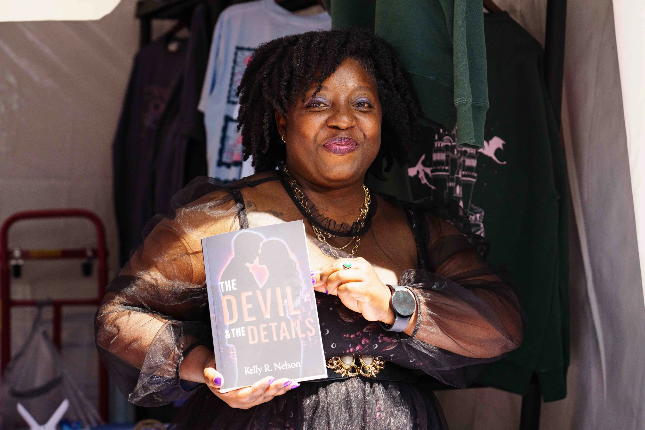  Indie romance author Kelly R. Nelson holds a copy of her book, "The Devil and the Details," at the Los Angeles Times Festival of Books, Saturday, April 18, 2026, in Los Angeles, Calif. A literary festival that began in 1996, this year’s two-day annu