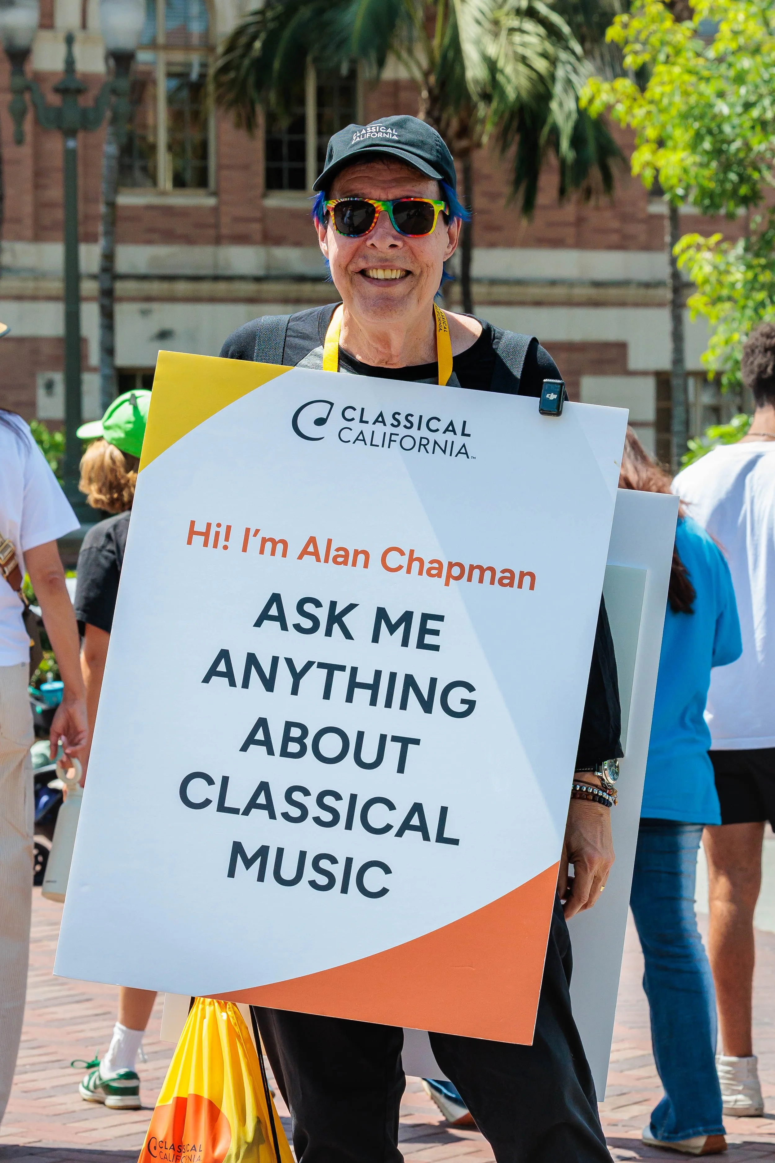  K-USC's Classical California radio personality Alan Chapman wears a sign inviting people to ask him questions while walking through the crowd during the 31st annual Los Angeles Times Festival of Books held at University of Southern California in Los