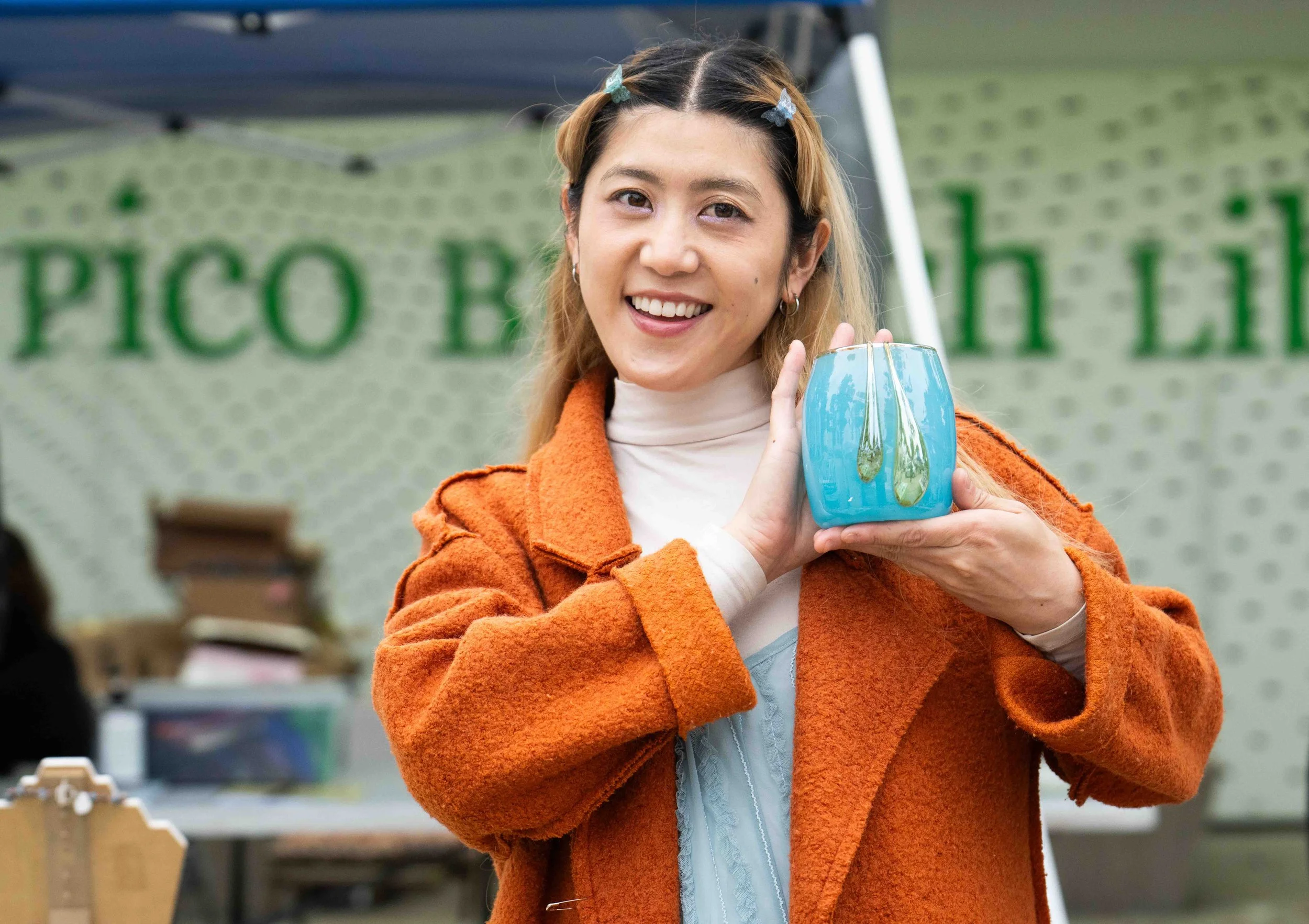  Santa Monica College (SMC) student Haneul Park holds one of her pieces for sale during SMC Art Department's Mother's Day Glass Sale at Virginia Park Farmers Market in Santa Monica, Calif., Saturday, May 2, 2026. Park was a sculptor before she began 