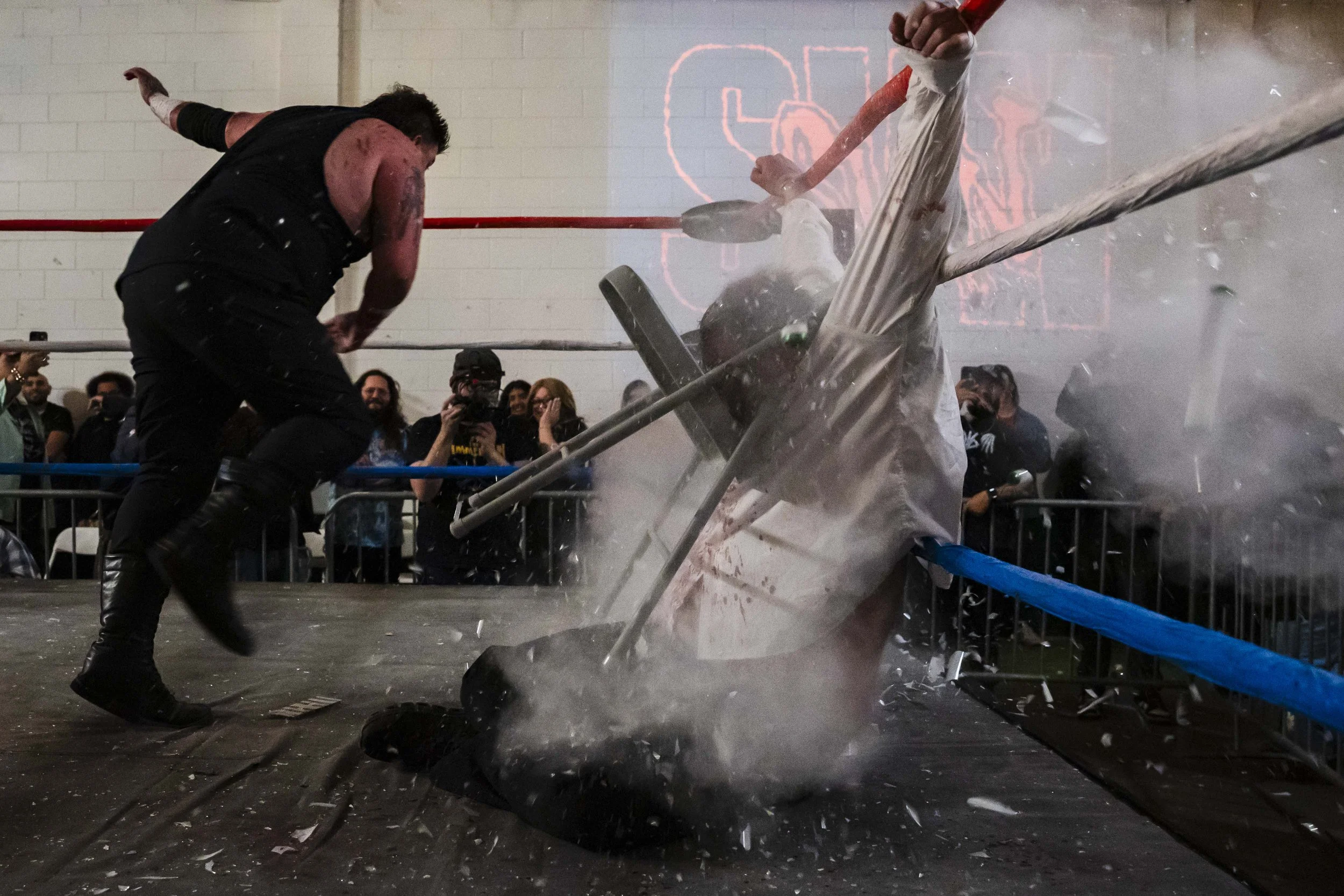  Deathmatch wrestler Joe Dred (L) throws a bundle of light tubes at Phil Insane (R) inside the LA Church in Los Angeles on Saturday, Jan. 17, 2026, during Insane’s retirement announcement. (Kayjel J. Mairena | The Corsair) 