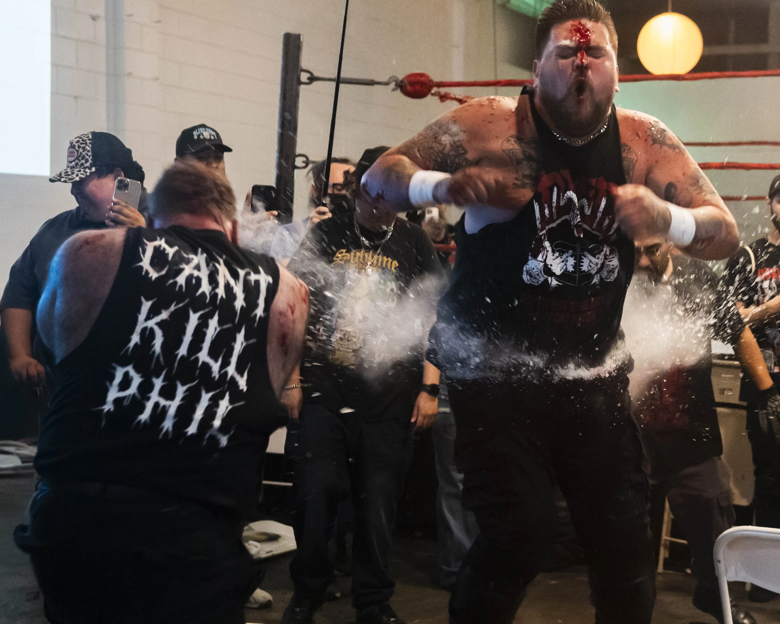  Deathmatch wrestler Phil Insane (L) swings a glass tube at Joe Dred (R) inside the LA Church in Los Angeles on Saturday, May 16, 2026, four months after Dred tried killing him in the ring. (Kayjel J. Mairena | The Corsair) 