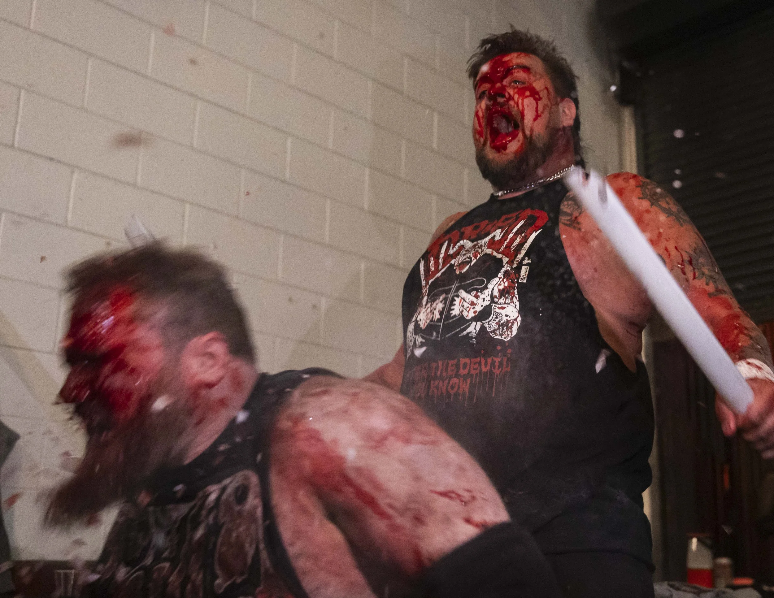  Deathmatch wrestler Phil Insane reacts (L) to having a light tube broken in his mouth by Joe Dred (R) inside the LA Church in Los Angeles on Saturday, May 16, 2026, during a match. (Kayjel J. Mairena | The Corsair) 