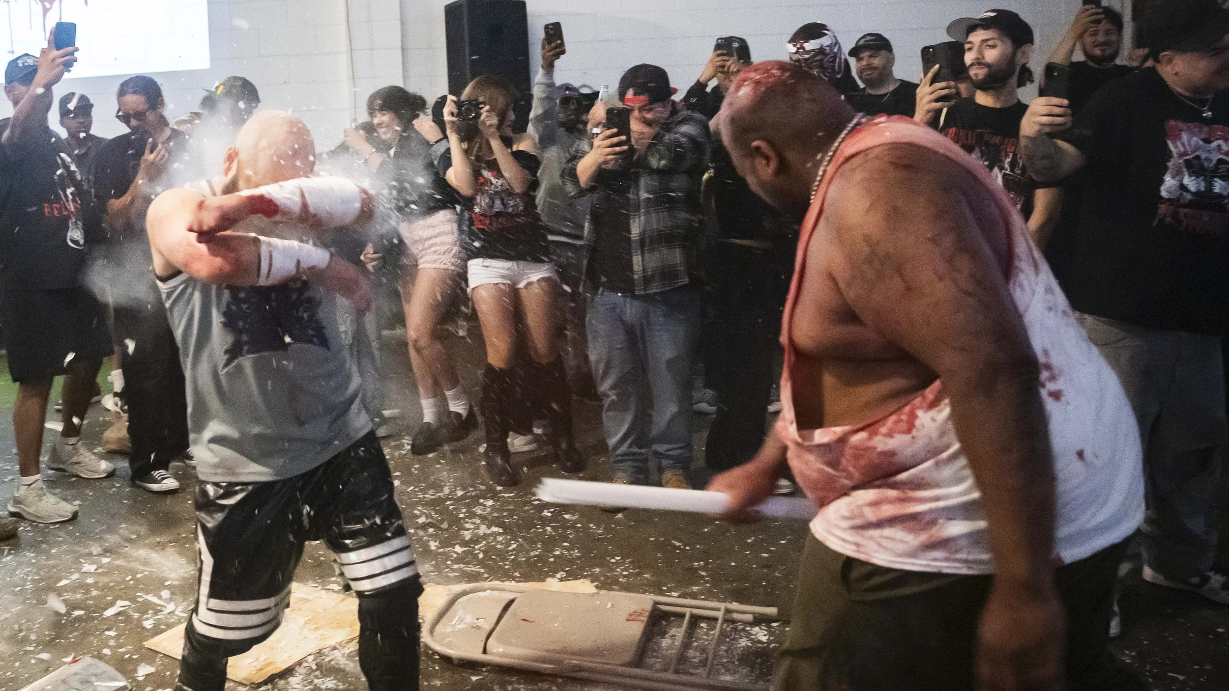  Deathmatch wrestler Alex Colon (L) blocks a light tube that was swung at him by Hoodfoot (R) during a match inside the LA Church in Los Angeles on Saturday, May 16, 2026. (Kayjel J. Mairena | The Corsair) 