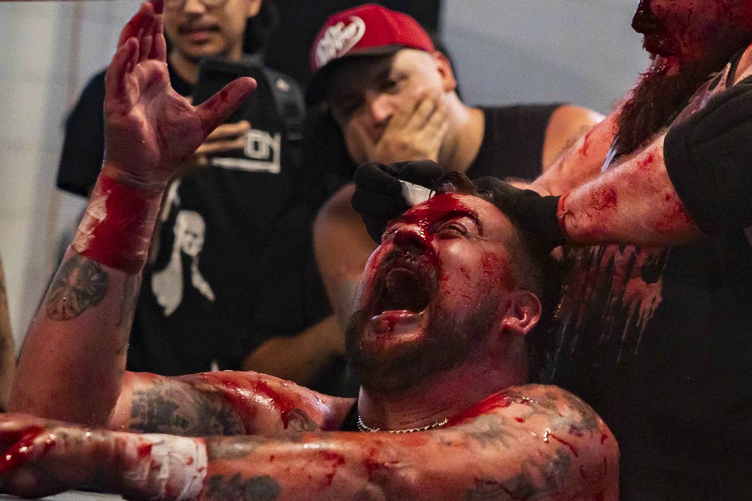  Deathmatch wrestler Joe Dred (L) screams as his opponent, Phil Insane (R), pours salt on an open wound during a match inside the LA Church in Los Angeles on Saturday, May 16, 2026. (Kayjel J. Mairena | The Corsair) 