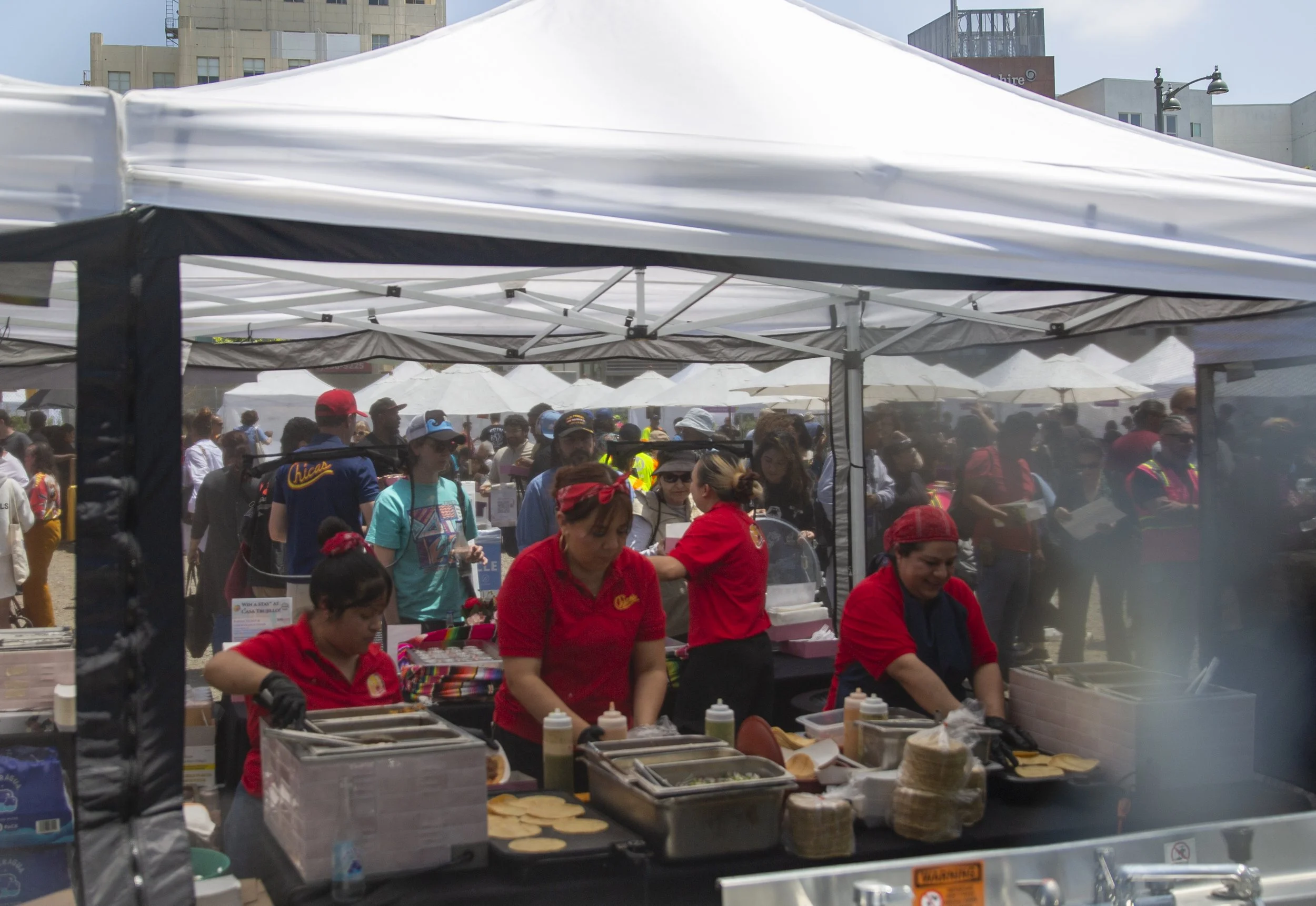  Food vendors prepare food for attendees during an opening celebration for Metro’s D Line Extension Section 1 outside the Wilshire/La Brea Station in Los Angeles on Friday, May 8, 2026. (Jinhao Tian | The Corsair) 