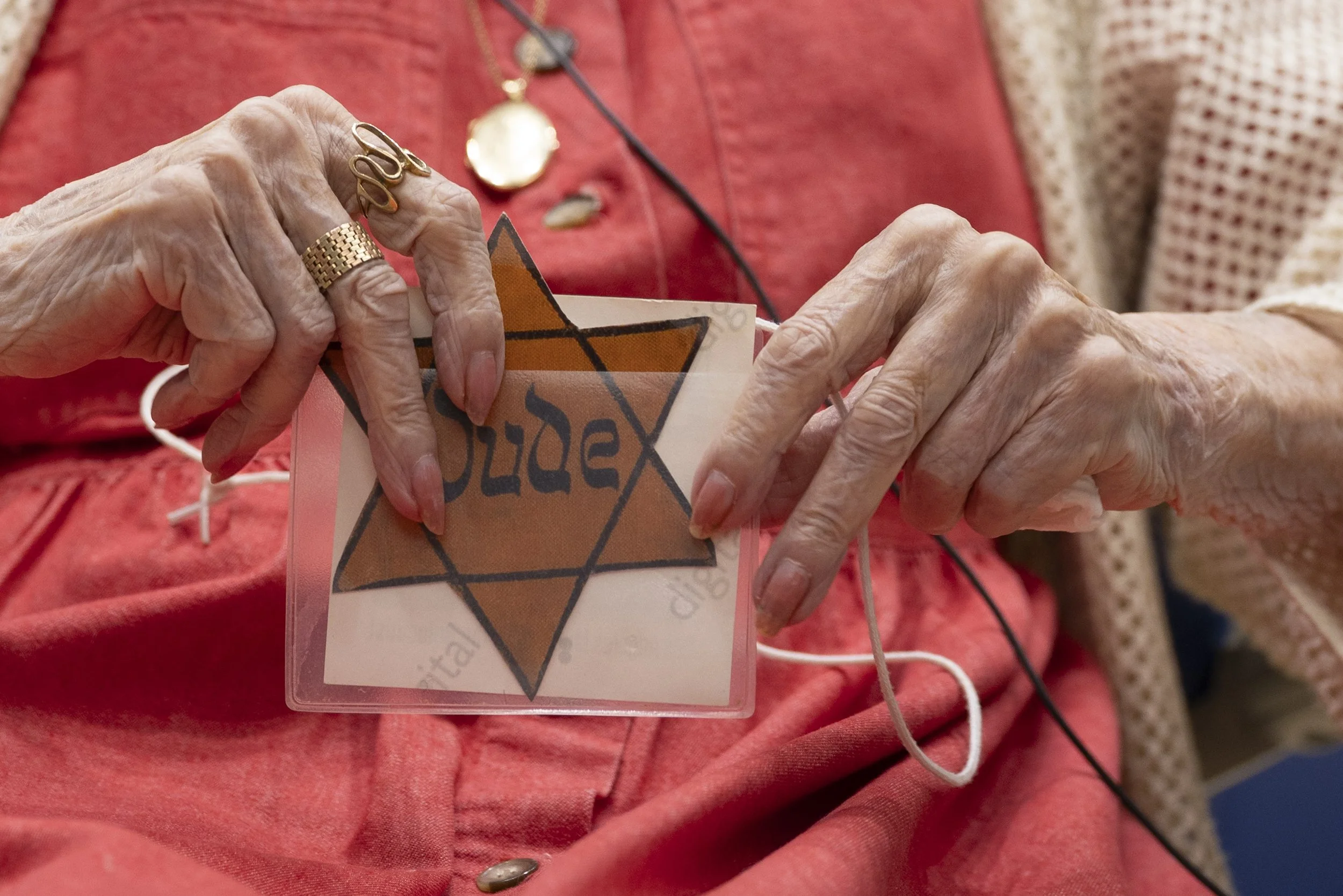  Mary Bauer, a nearly 99-year-old Holocaust survivor, holds a badge in the shape of the Star of David with the German word ‘Jude’ (Jew) written on during the event ‘A Conversation with Holocaust Survivor Mary Bauer’ on Thursday, May 21, 2026, at Sant