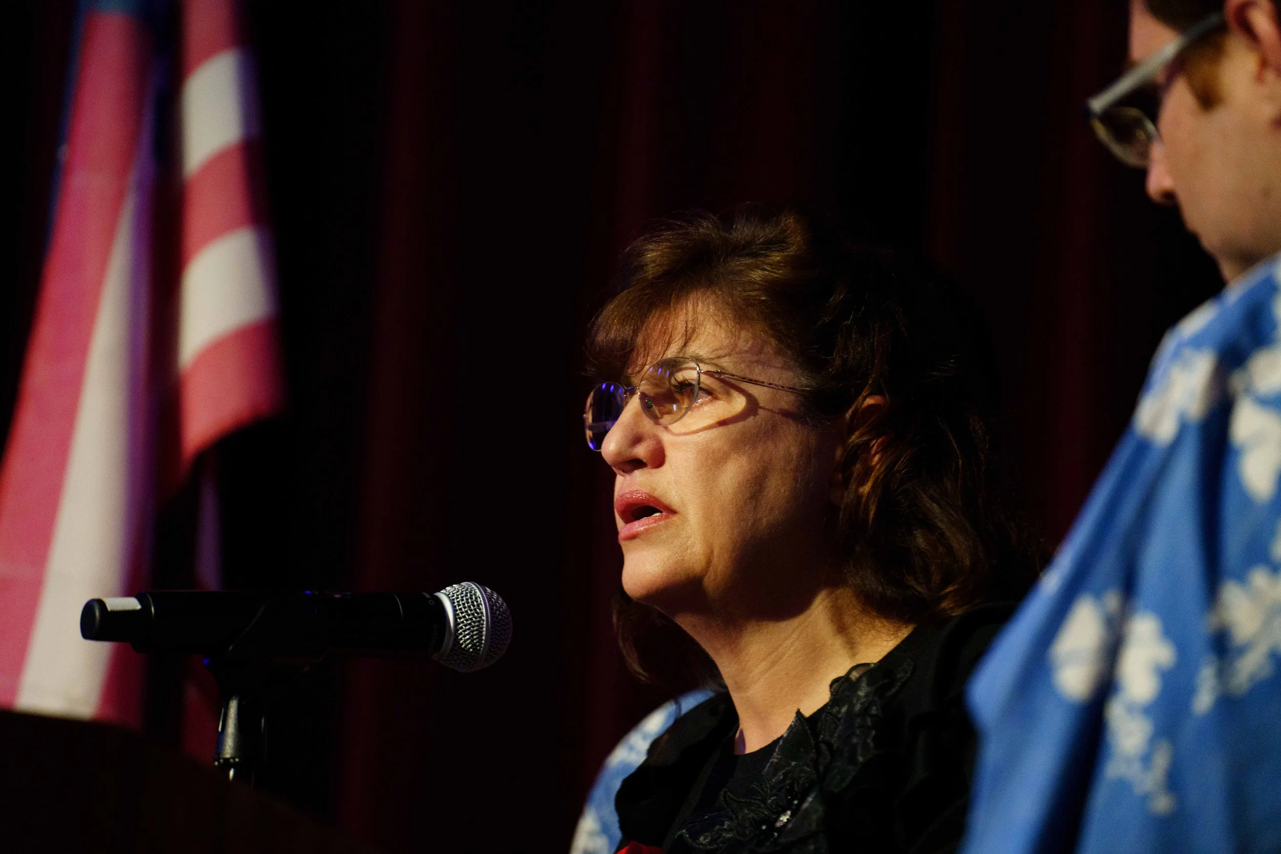  Santa Monica College (SMC) Veterans' Resource Center Student Services Specialist and Certifying Official Martha Romano (center) with her son (R) speaks during a Celebration of Life for her husband, retired SMC Police Captain and U.S. Marine Corps ve