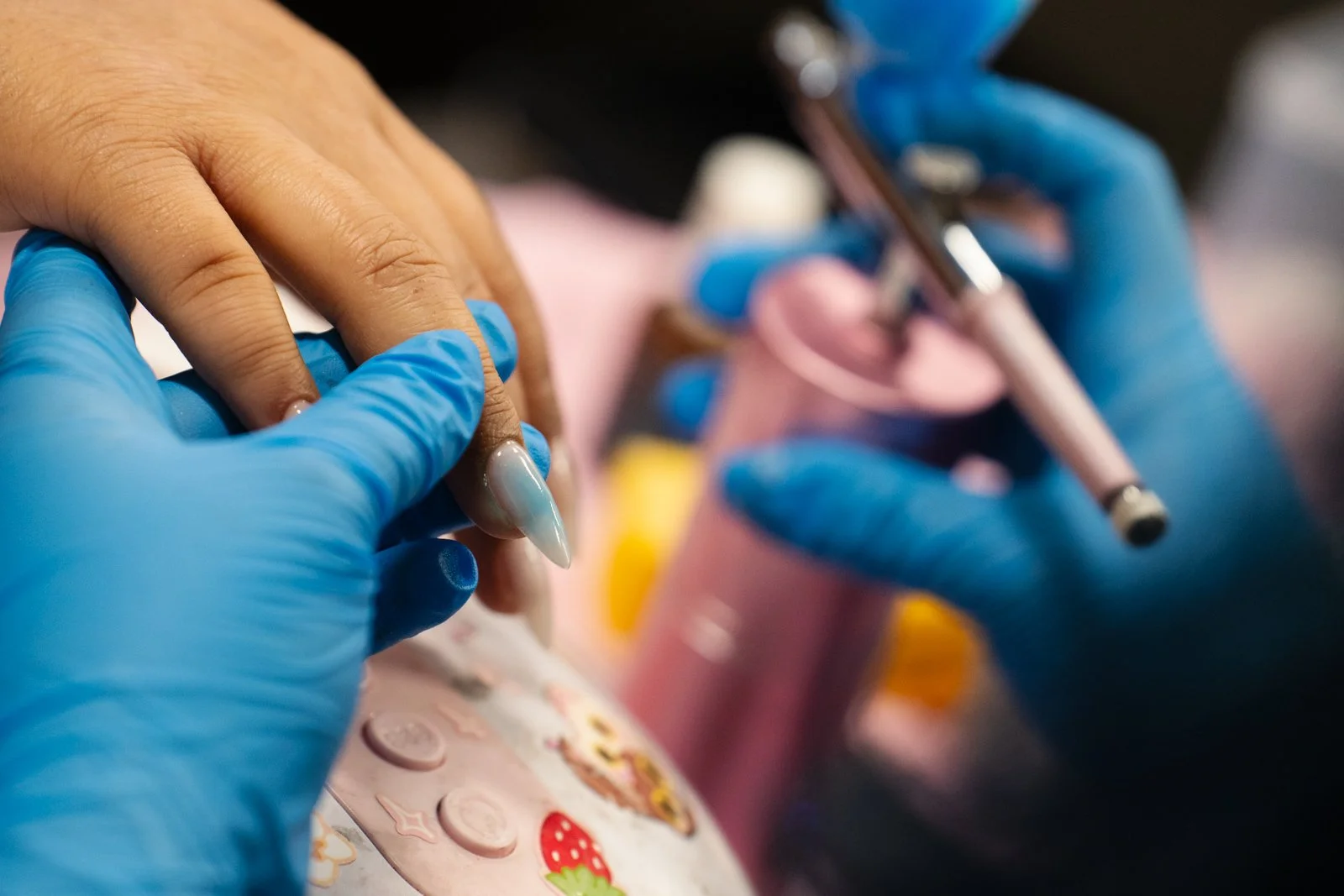  Second-year Santa Monica College (SMC) cosmetology major Lesli Stephani Vargas Martinez during the process of applying airbrush color to SMC student Nautica Ochoa’s Gel-X nails inside the cosmetology department’s salon at the SMC Business Building i