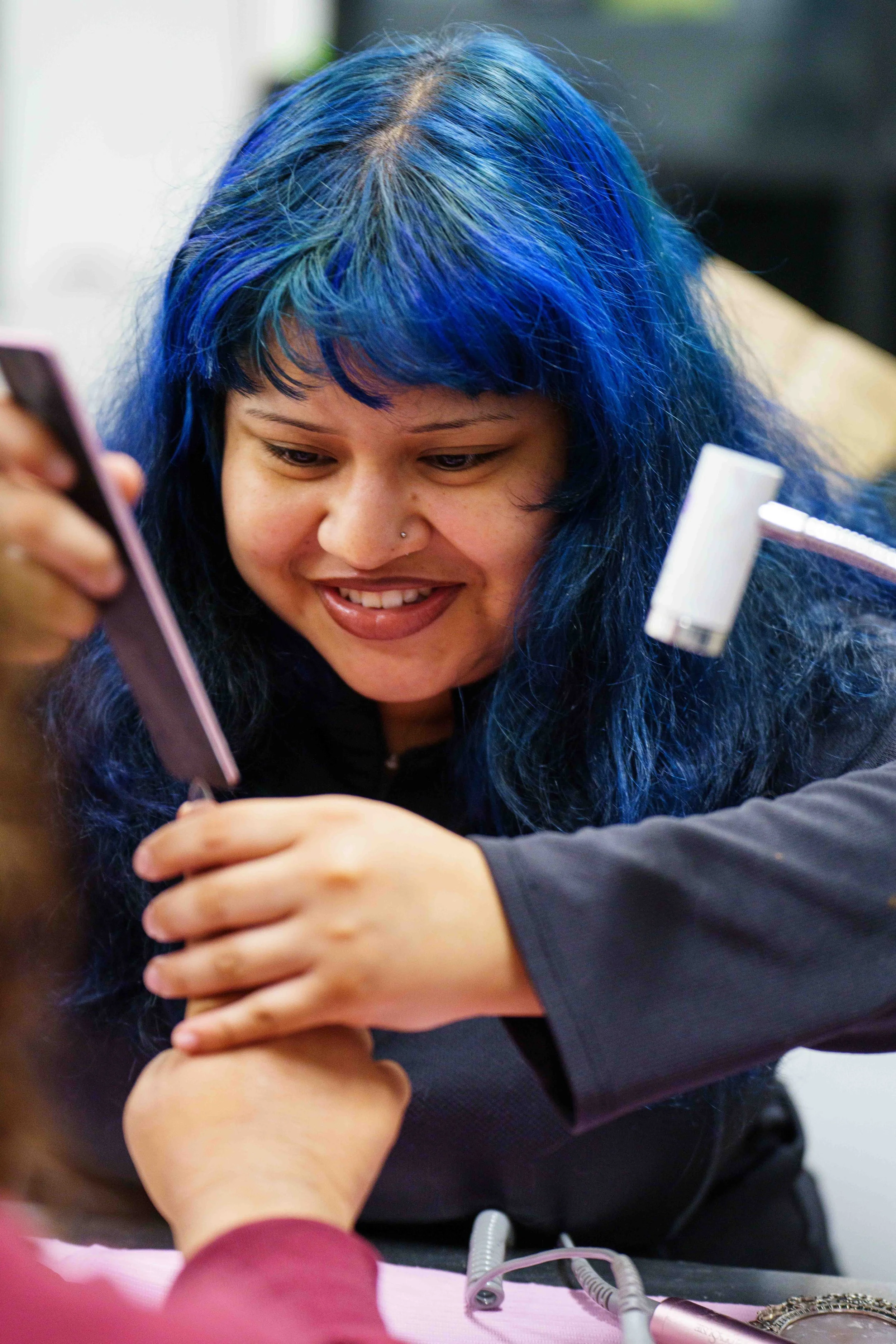  Second-year Santa Monica College (SMC) cosmetology major Lesli Stephani Vargas Martinez files SMC student Nautica Ochoa’s nails inside the cosmetology department’s salon at the SMC Business Building in Santa Monica, Calif., Tuesday, June 2, 2026. (E