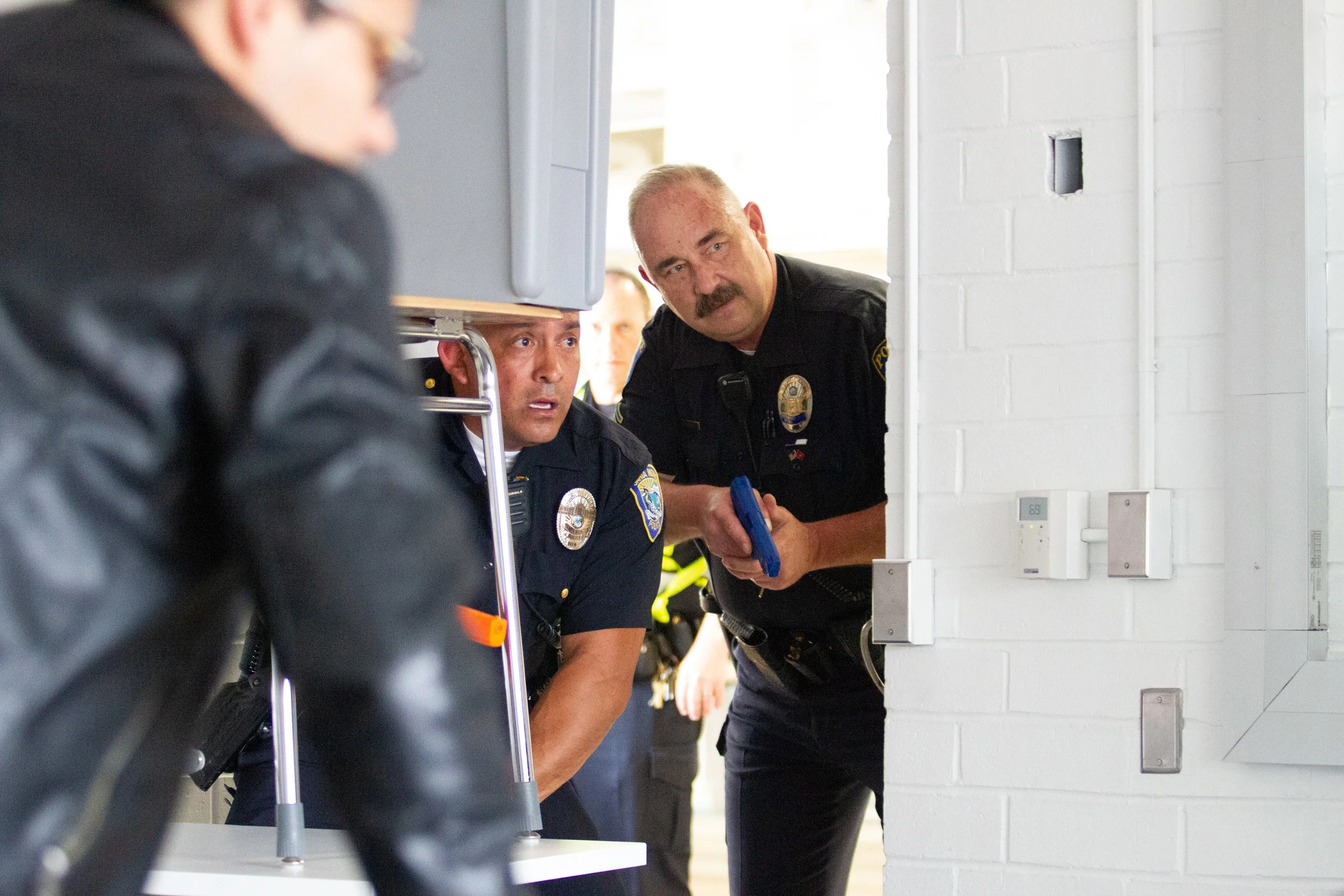  Santa Monica Police Department Officer Angel (left) and Santa Monica College (SMC) Police Department Sergeant Jere Romano (right) enter a classroom on the second floor of D Building during an Active Shooter Drill, Friday, March 1, 2019, at the SMC C