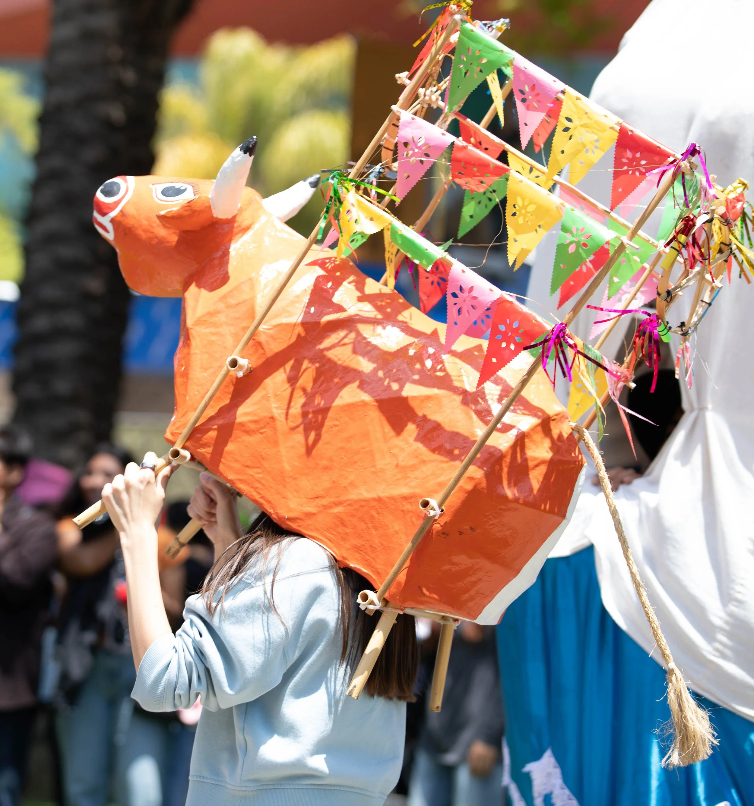  A reveler dances with a mojiganga and enjoys the festivities at the Oaxacans's at SMC (Santa Monica College) Guelaguetza 2026 on Thursday, May 28 2026 at the Santa Monica College main quad at 1900 Pico Blvd. in Santa Monica, CA. (Maria Lebedev | The