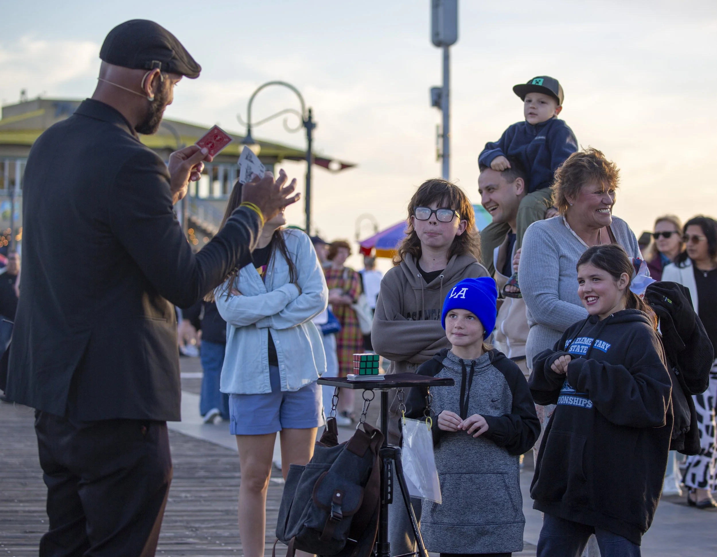  Visitors watch as street magician Ronascherman performs a card trick at the Santa Monica Pier in Santa Monica, Calif., on Thursday, April 23, 2026. (Jinhao Tian | The Corsair) 
