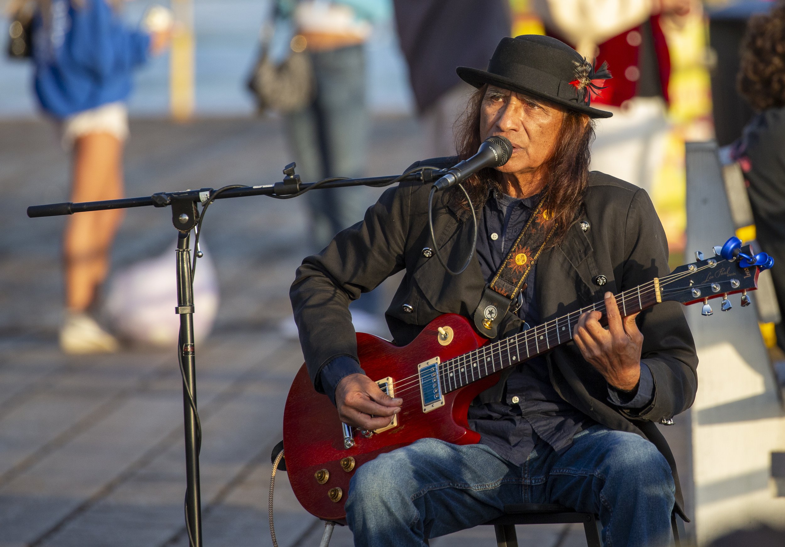  A street performer sings into a microphone while playing guitar for visitors at the Santa Monica Pier in Santa Monica, Calif., on Friday, May 1, 2026. (Jinhao Tian | The Corsair) 