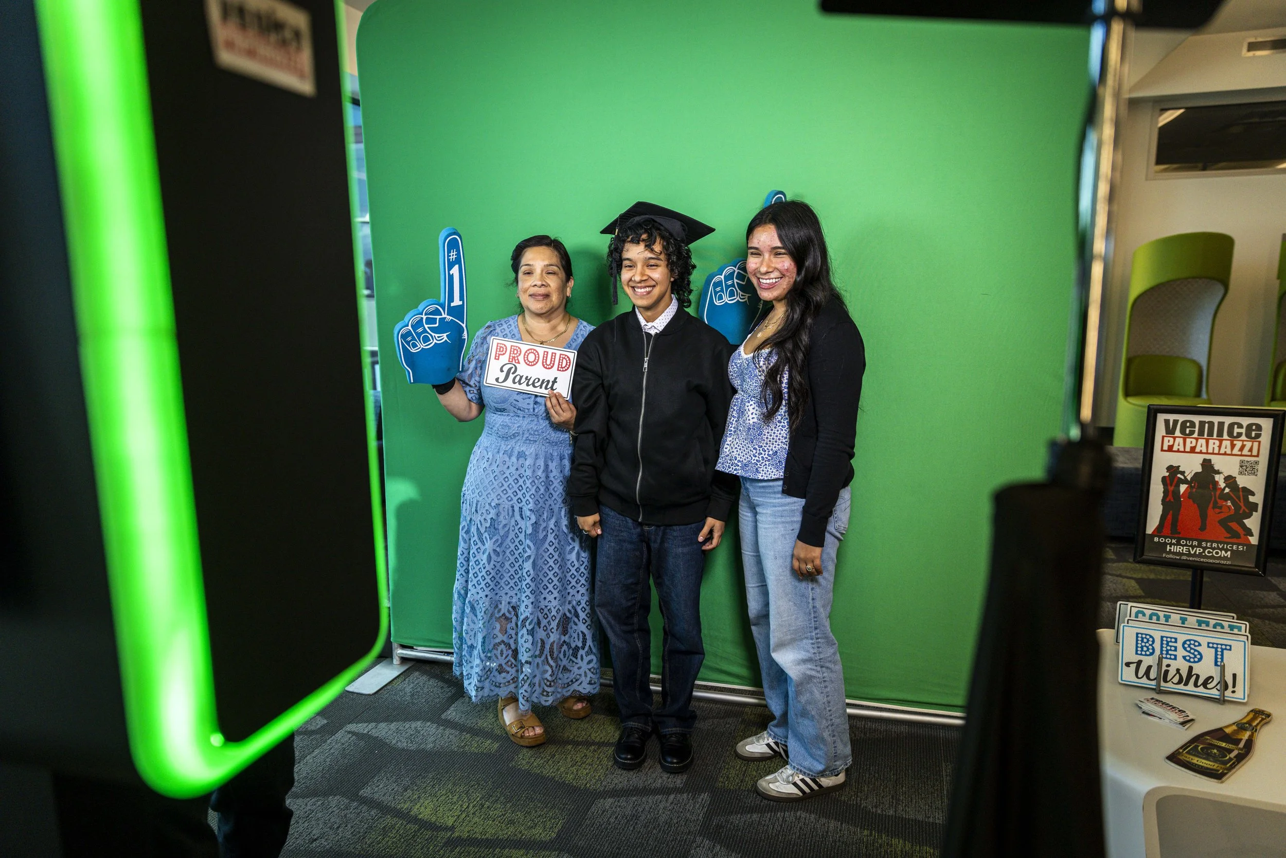  New Santa Monica College (SMC) graduate Alex Enriquez (C) poses in the photo booth with his mother, Susana Enriquez (L), and little sister Melissa Enriques (R) during the Student Equity Center celebration for LGBTQIA2S+ graduates from the Class of 2