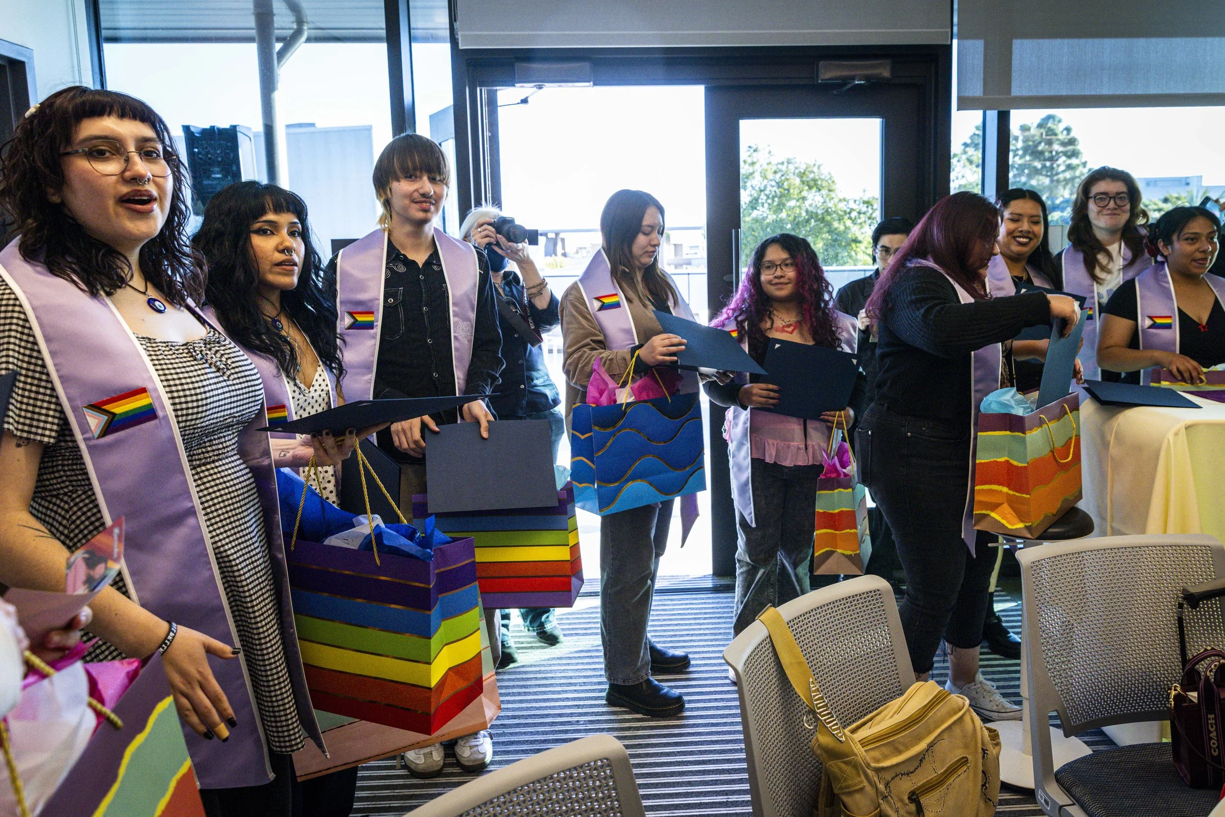  New Santa Monica College (SMC) graduates watch their peers receive their certificates, caps and stoles during the Student Equity Center celebration for LGBTQIA2S+ graduates from the Class of 2026 on Wednesday, May 27, 2026, in the Student Services C