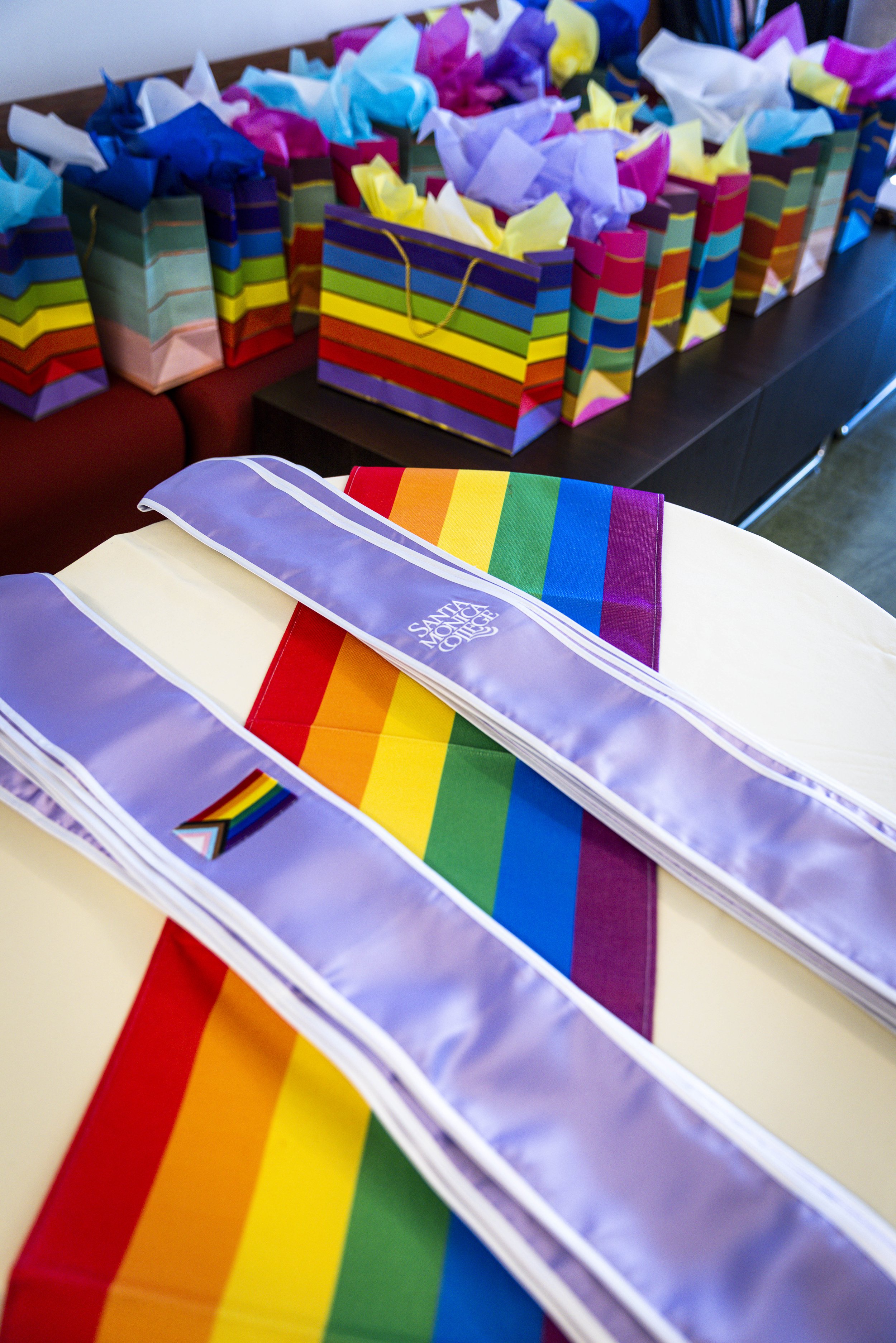  Stoles sit on a table with gift bags in the background during the Santa Monica College (SMC) Student Equity Center celebration for the LGBTQIA2S+ graduates from the Class of 2026 on Wednesday, May 27, 2026, in the Student Services Center’s Faculty R