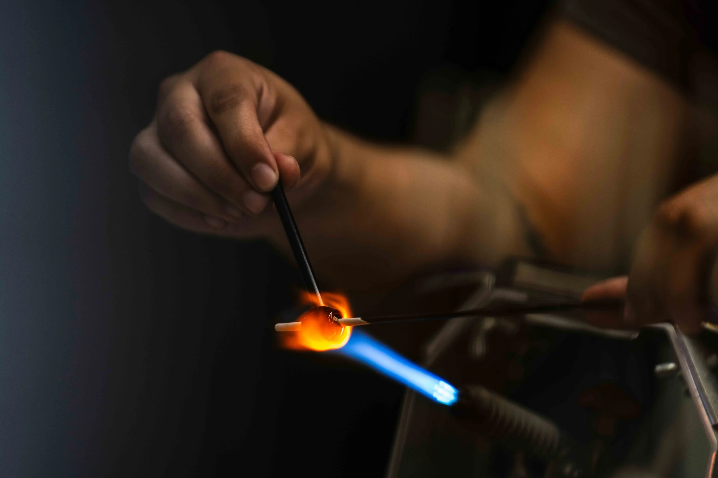  Santa Monica College (SMC) student Angel Oyez shapes a glass bead at a torch work station set up next to the hot shop in the SMC Art Complex in Santa Monica, Calif., Friday, June 5, 2026. Molten glass is wrapped around a stick called a mandrel and t