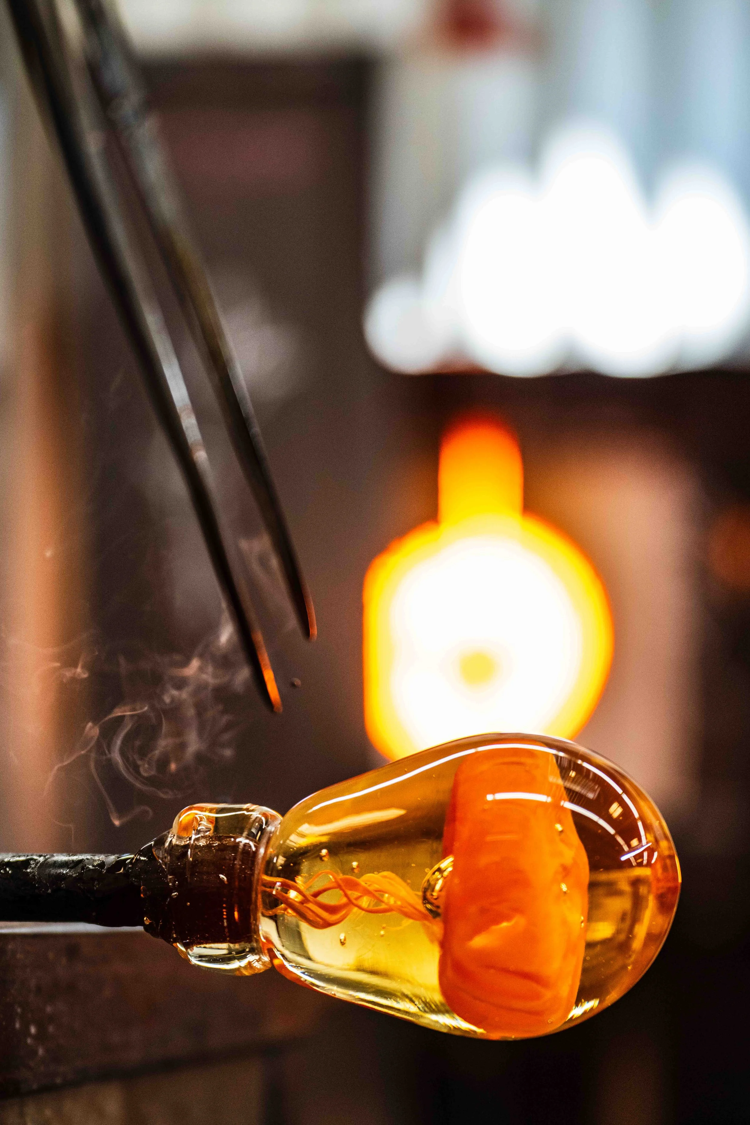  Smoke comes off of tweezers as Santa Monica College (SMC) student Julian Bender creates a jellyfish themed chess piece for a complete set to serve as his final project for the semester. He chose the jellyfish theme because he was previously a marine