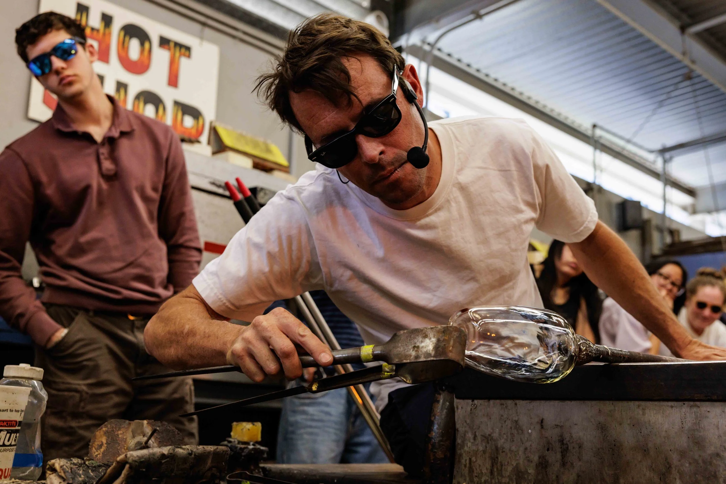  Los Angeles based glass and metalwork artist Evan Chambers (center) performs a demonstration after a guest lecture for Santa Monica College's (SMC) glass sculpture class, all in protective eyewear, in the hot shop at SMC's arts complex in Santa Moni
