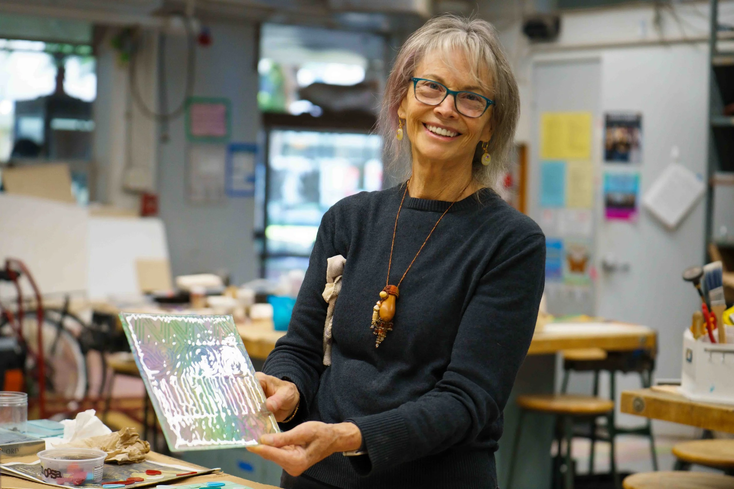  Denise Bachman, a student of both the Santa Monica College (SMC) glass sculpture and glass fusing classes, poses for a portrait holding one of her fusing pieces at the SMC Art Complex in Santa Monica, Calif. on Friday, Jan. 30, 2026. Glass sculpture