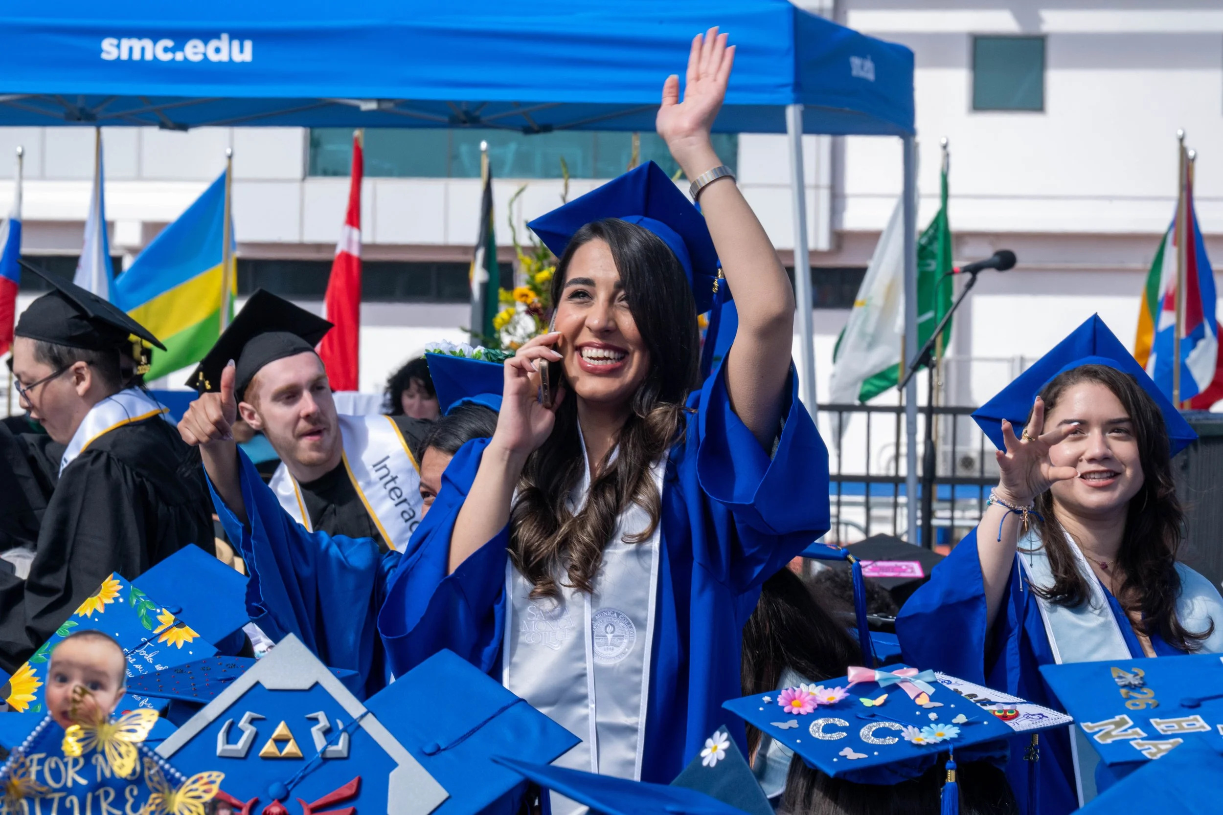  Santa Monica College (SMC) 2026 Graduation Ceremony students contacting family in the audience at the Corsair Stadium, Santa Monica, Calif., on Tuesday, June 16, 2026. (Tom Rosholt | The Corsair) 