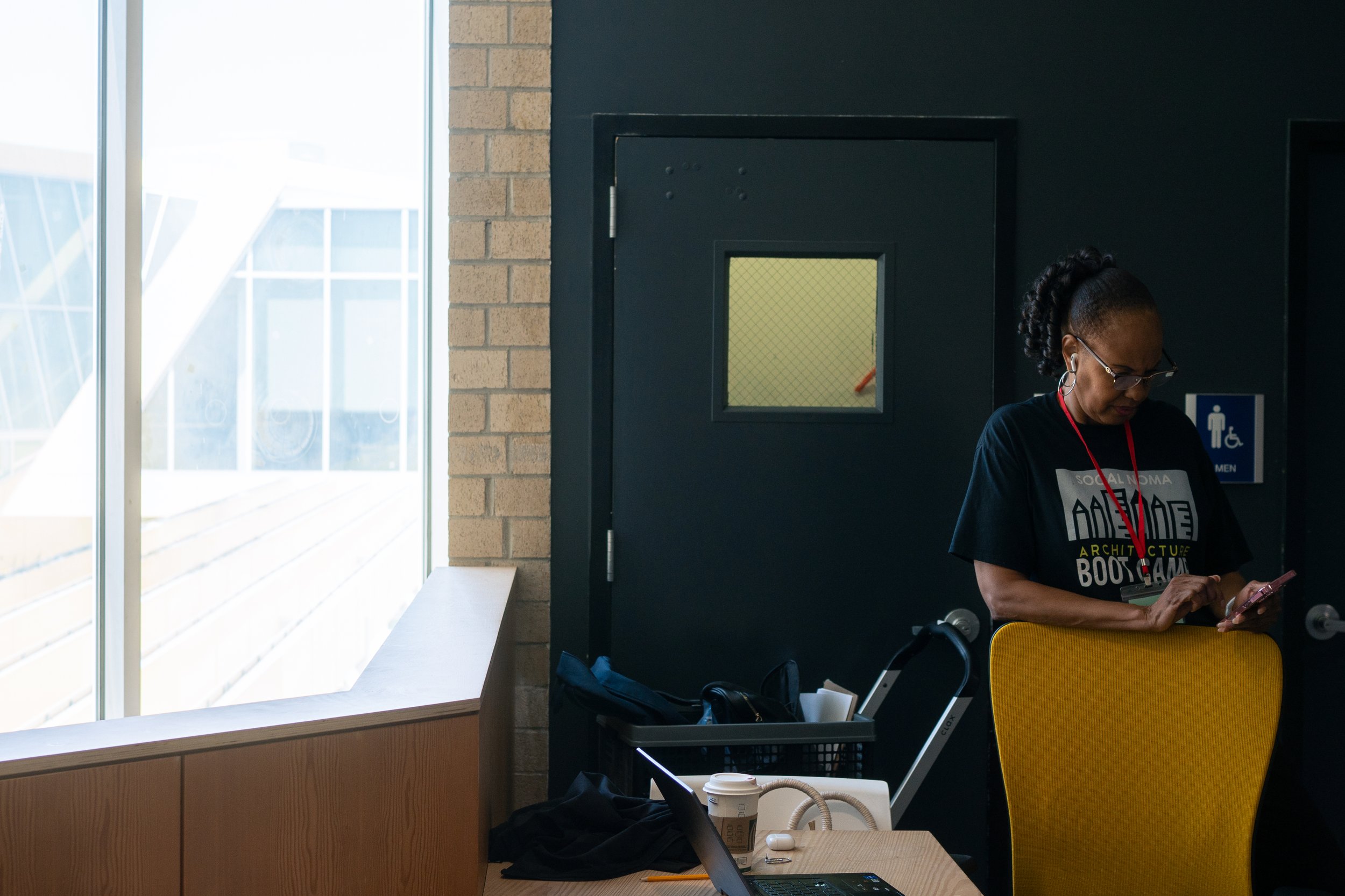  Eletrice Harris, the Director for the Project Pipeline Programs at SoCal NOMA, stands over her desk during their annual Architecture Boot Camp, hosted by Santa Monica College's Center for Media and Design, Friday, July 24, in Santa Monica, Calif. (N