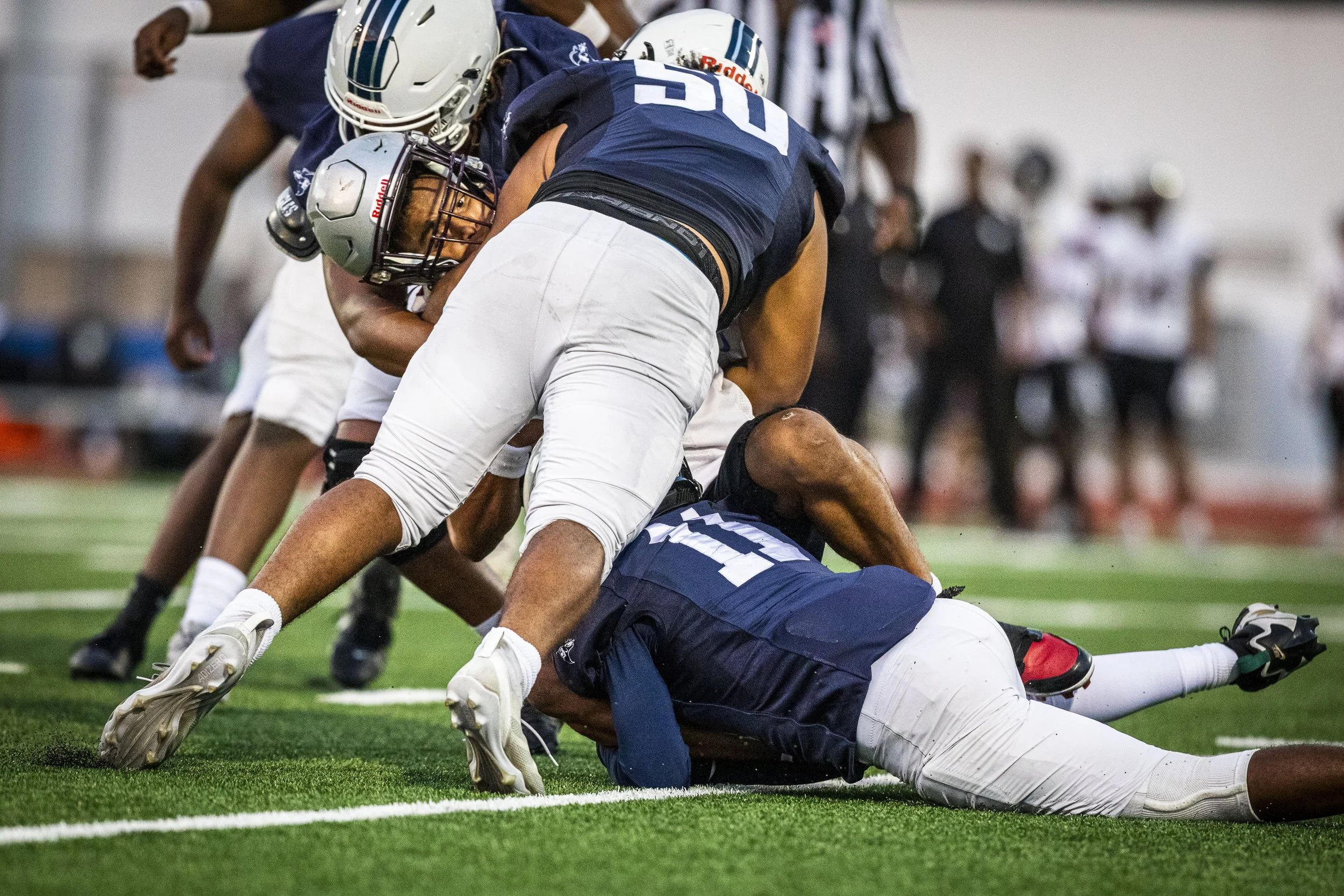 Compton College Coyotes WR Tyler Esqueda-Johnson (12) (Center) is tackled by Santa Monica College (SMC) Corsair players during their match on Saturday, Sept. 5, 2026, at the SMC Corsair Stadium in Santa Monica, Calif. The Corsairs beat the Coyotes 5