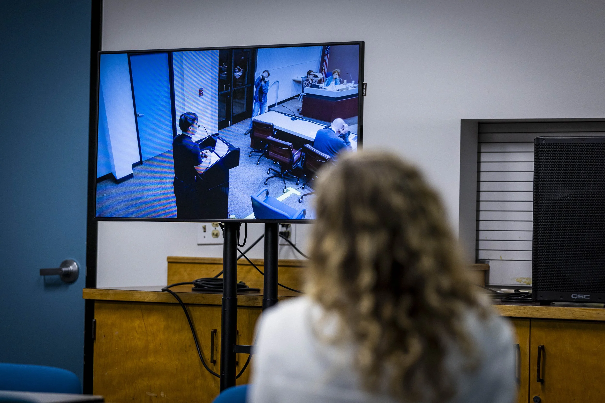  Santa Monica College (SMC) Dean of Community & Academic Relations, Dr. Kiersten Elliott watches Associated Students Vice President Gabriel Sanchez on the screen in the Conference Center as he addresses the SMC Board of Trustees during a meeting on T