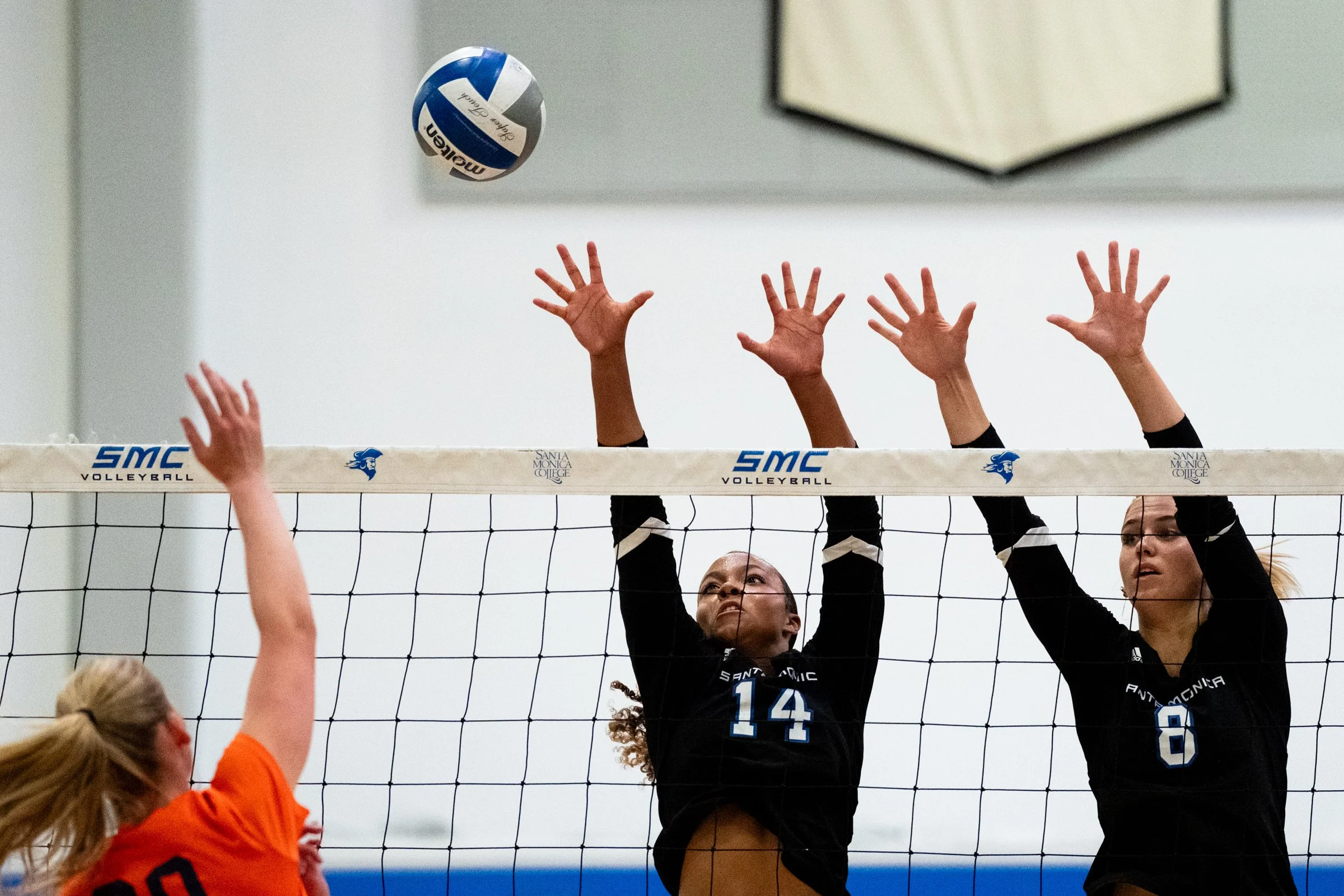 Santa Monica College (SMC) Corsairs Women’s Volleyball Outside Hitter, Quinci Wilder (14) and Middle Blocker, Anna Hockett (8) jumping to block the ball during a game against Orange Coast Pirates in Santa Monica on Friday, Sept 11, 2026. Corsairs wi