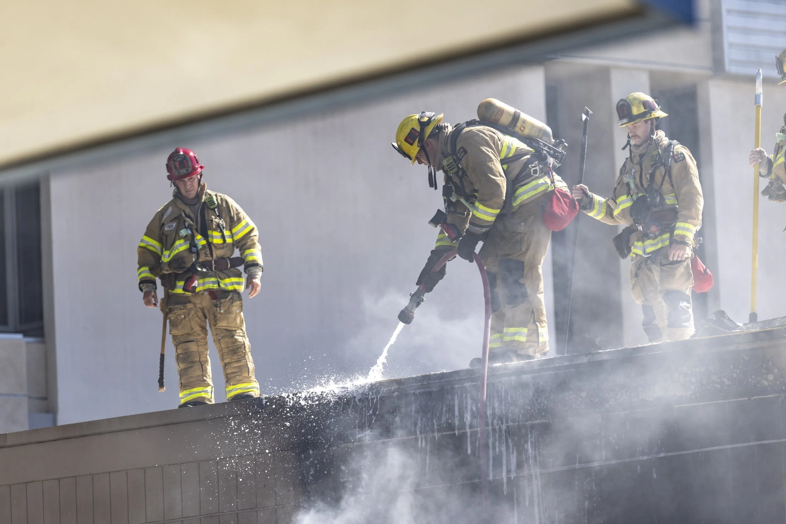  Firemen from the Santa Monica Fire Department (SMFD) extinguishing a fire inside the walls of Classroom 171 during a dumpster fire at the Santa Monica College (SMC) Main Campus on Pico Blvd, Santa Monica, Calif. The fire ignited by a lit cigarette, 