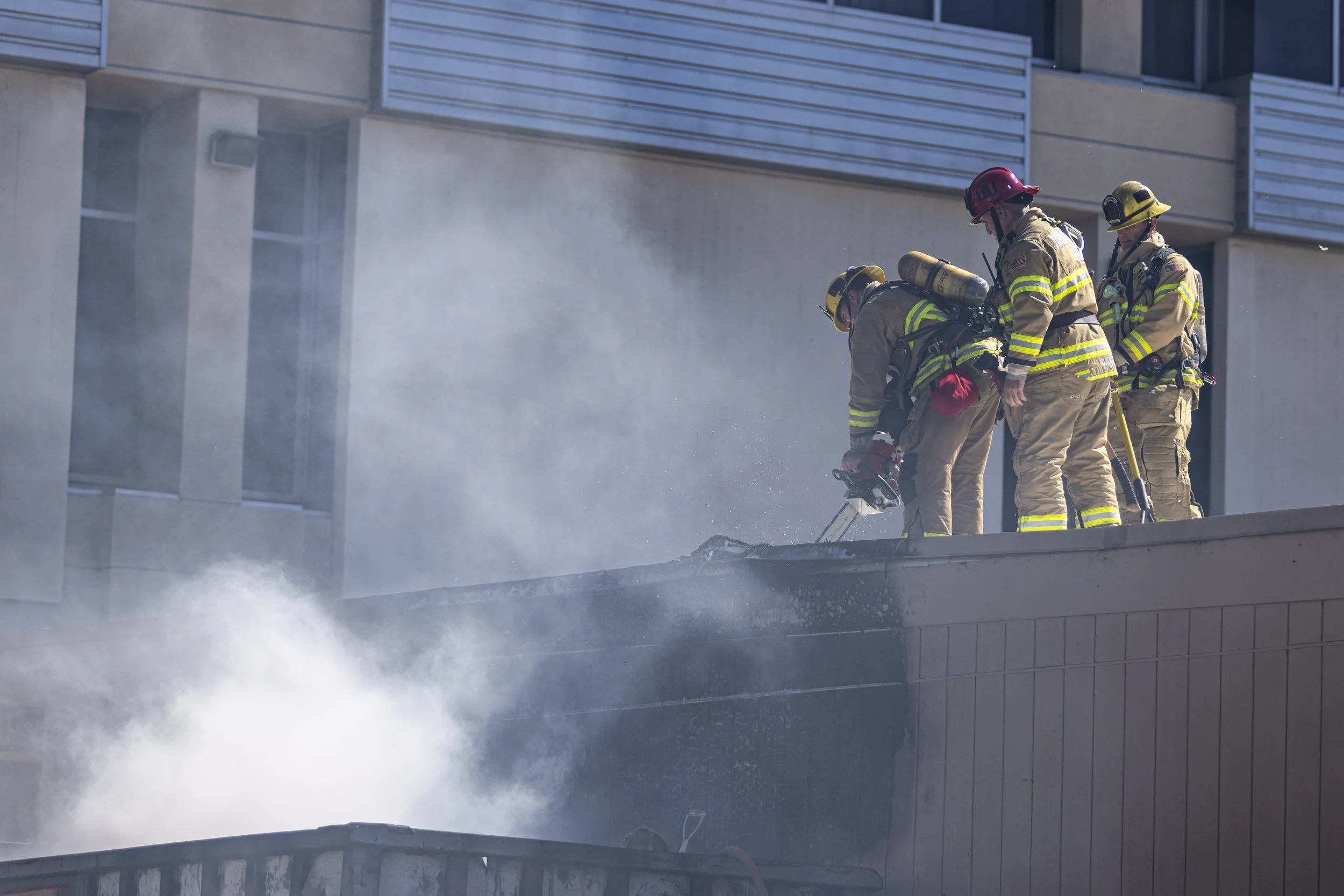  Firemen from the Santa Monica Fire Department (SMFD) opening the roof and walls of Classroom 171 during a dumpster fire at the Santa Monica College (SMC) Main Campus on Pico Blvd, Santa Monica, Calif. The fire ignited by a lit cigarette, burning the
