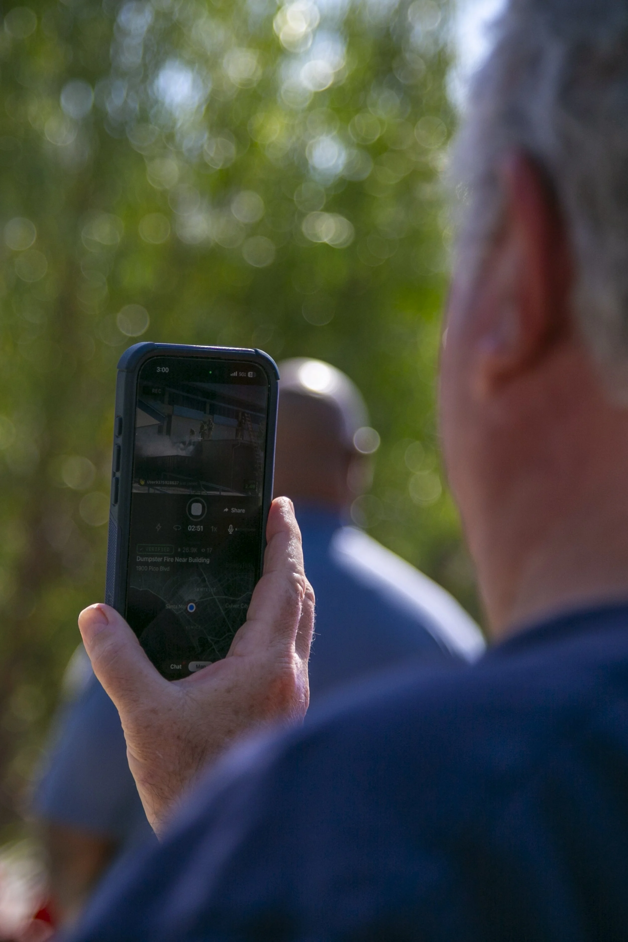 A person livestreaming the dumpster fire on the Citizen app at the SMC Main Campus on Pico Blvd, Santa Monica, Calif. The fire ignited by a lit cigarette, burning the trash inside the dumpster and part of Math Classroom 171 in the Main Campus. (Jord