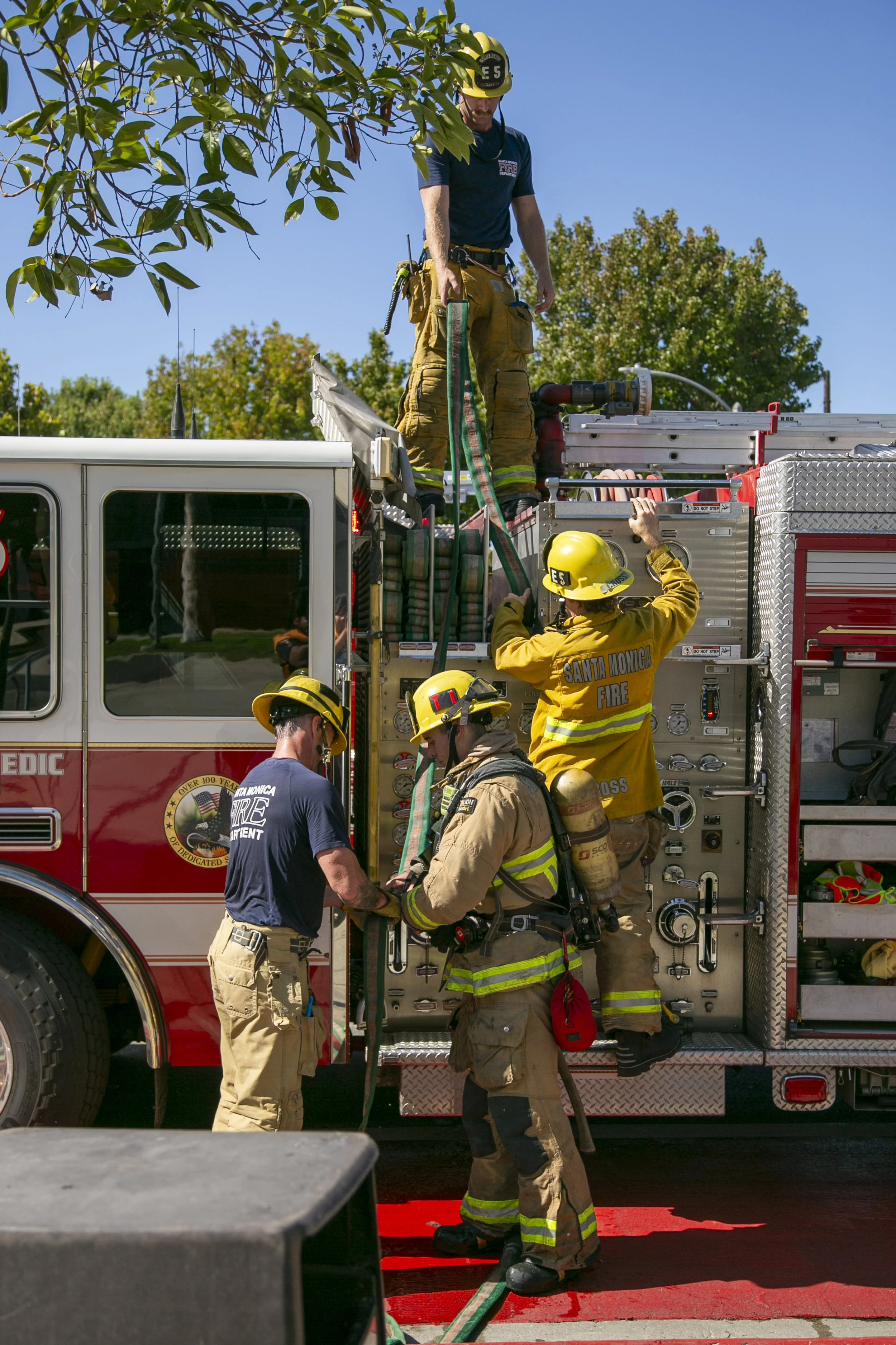  Santa Monica Fire Department (SMFD) Fire Engine 5 packing up after extinguishing a dumpster fire at the Santa Monica College (SMC) Main Campus on Pico Blvd, Santa Monica, Calif. The fire ignited by a lit cigarette, burning the trash inside the dumps