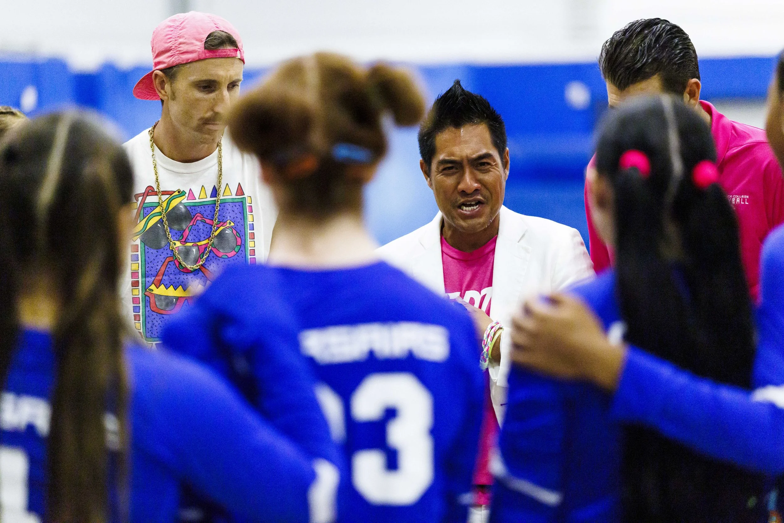  Santa Monica College (SMC) Corsair women's volleyball head coach Christian Cammayo (Center) gives instructions to his players surrounded by assistant coaches David Updegrove (Left) and Chris Chown (Right) during a timeout on their game against the S