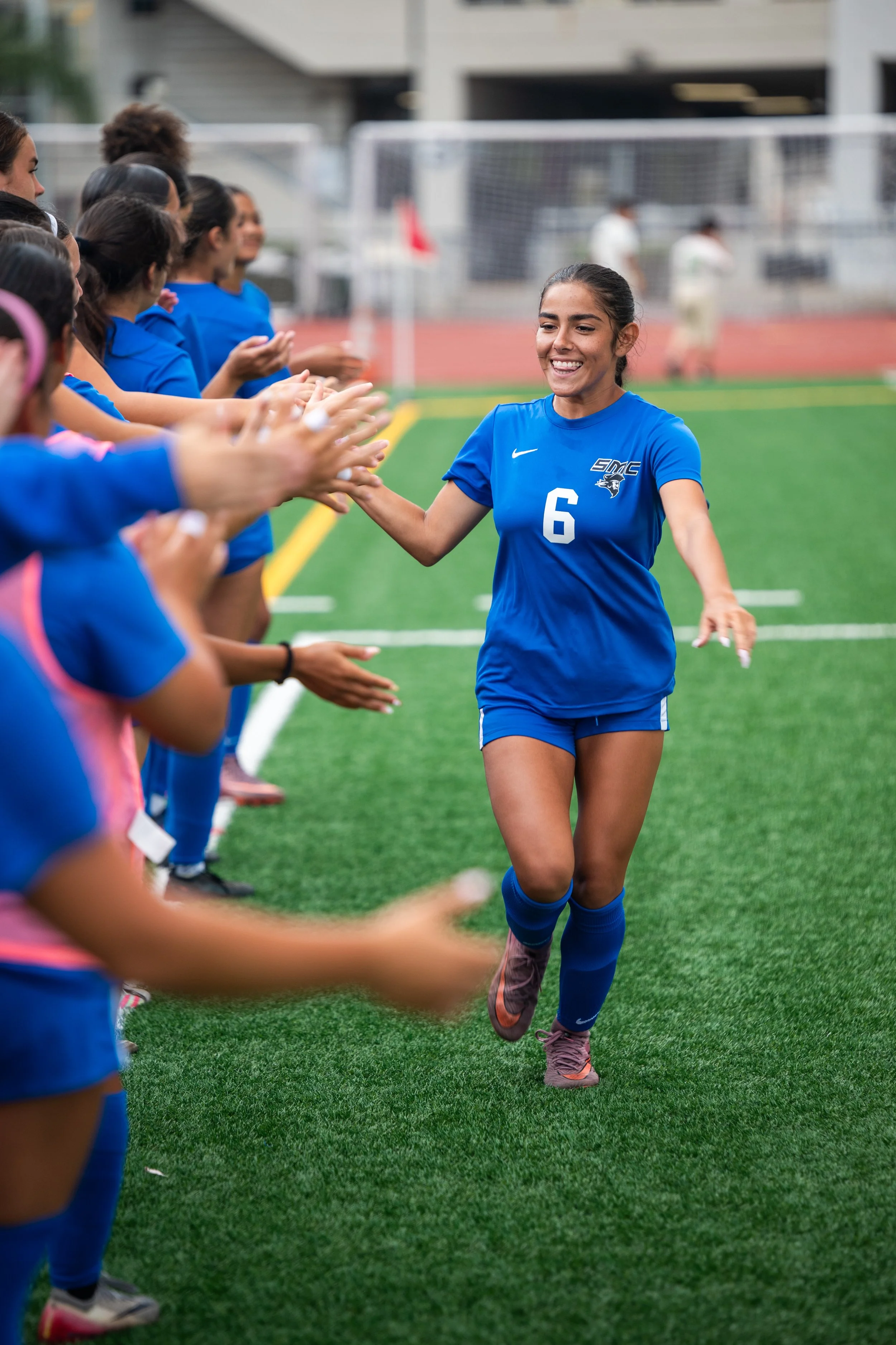  Santa Monica College (SMC) Corsair Alexa Burr (6) high-fiving teammates during player introductions prior to the game with Valley Community College Monarchs on Friday, September 25, 2026, in Santa Monica, Calif. The Corsair defeated the Monarchs 4-2