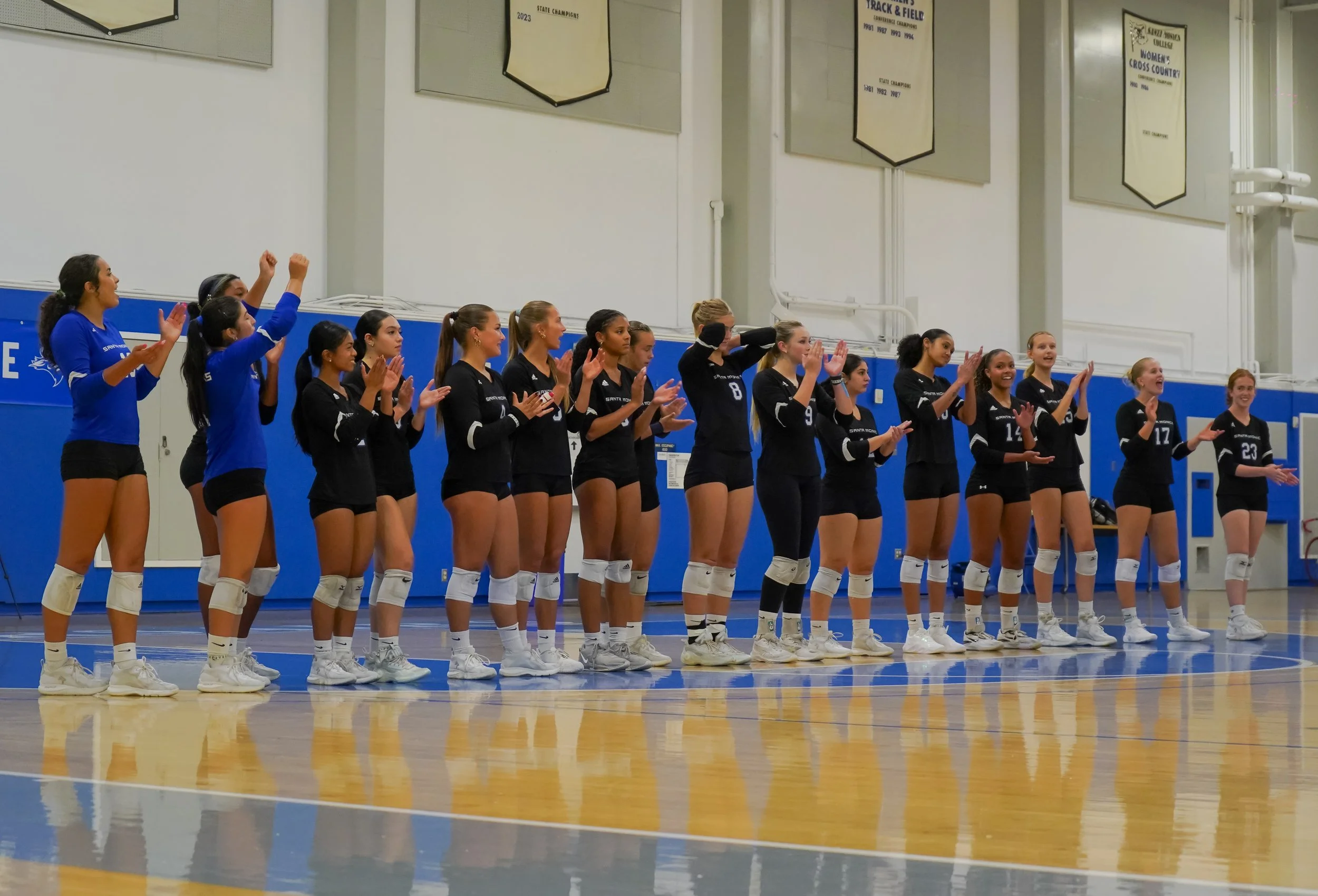  The Santa Monica College women's volleyball team lines up on the court for pregame introductions before home match against Cerritos College at Santa Monica College. The Corsairs stood side by side as their names were announced over the loudspeaker a