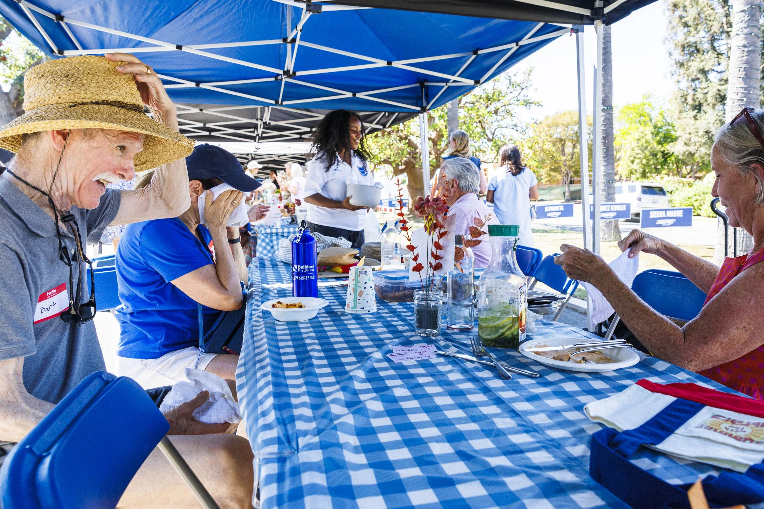  Pacific Palisades community members enjoy food and beverages and catch up despite the heat during the second annual Longest Table Potluck Picnic Sunday, Oct. 4, 2026, on Pampas Ricas Blvd. in Pacific Palisades, Calif. The event was organized by resi