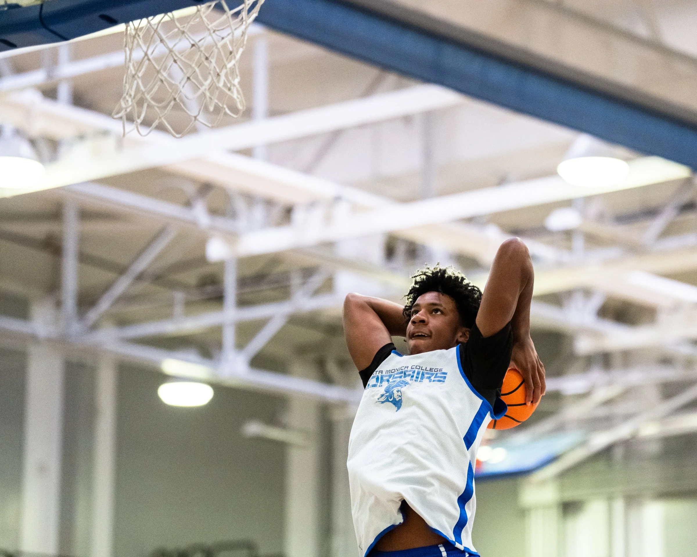  The Santa Monica College (SMC) Corsairs Men’s basketball Jaylen Brown (12) pulls the ball back behind his head before the two hand slam dunk against LA Harbor College Seahawks in the first half of the scrimmage game on Friday, Oct. 16, 2026, at Cors