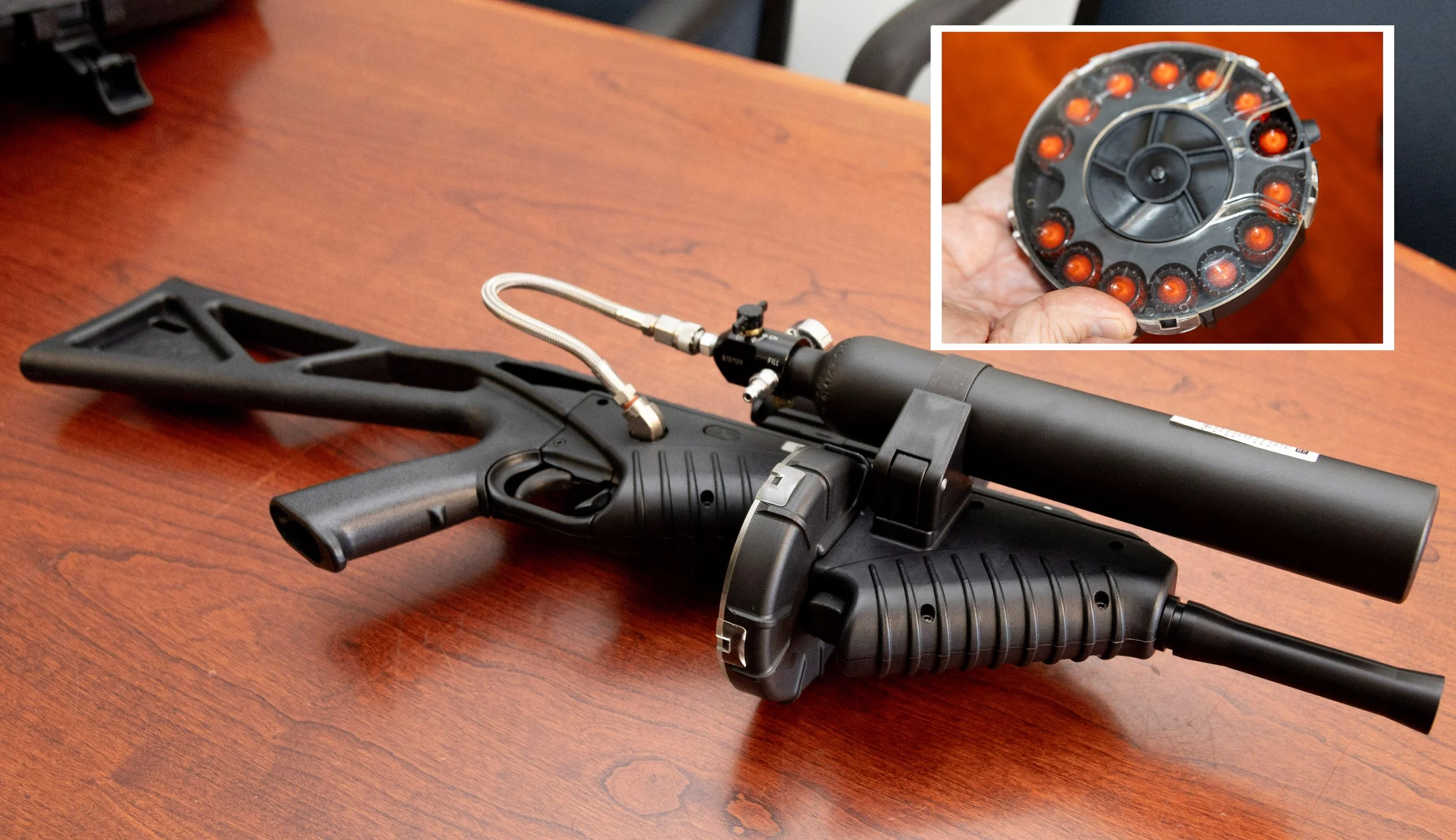  Photo illustration: An FN 303 semi-automatic less-lethal launcher on a table at the Santa Monica College Police Department in Santa Monica, Calif., Wednesday, October 7, 2026, with its compressed air tank visible. The FN 303 uses compressed air to f