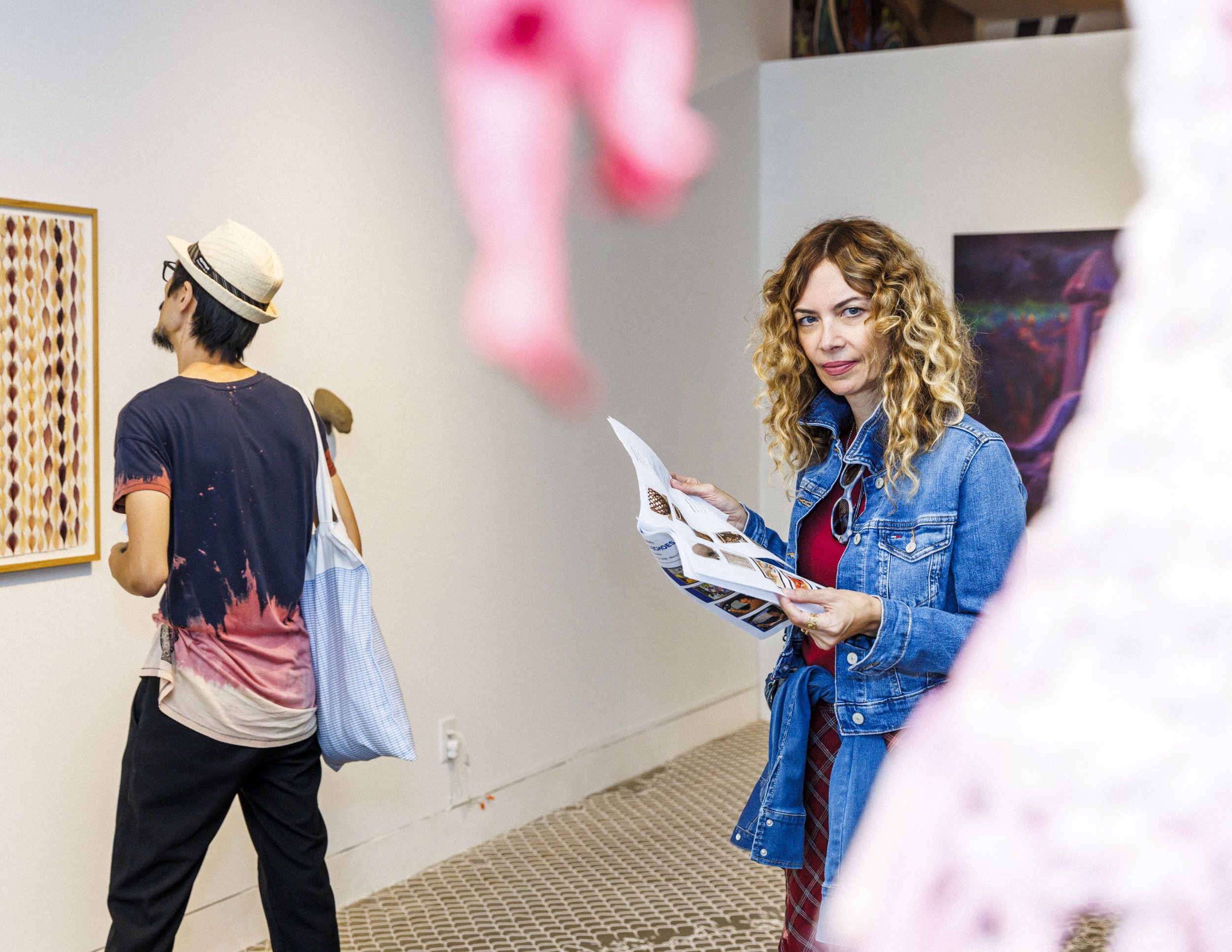  Santa Monica College (SMC) Art History professor Mina Majstorovic (cq) looks at a sculpture while browsing the artwork guide during the opening reception for the SMC Art Department "Living Echoes" exhibit on Tuesday, Oct. 13, 2026, at the Pete and S
