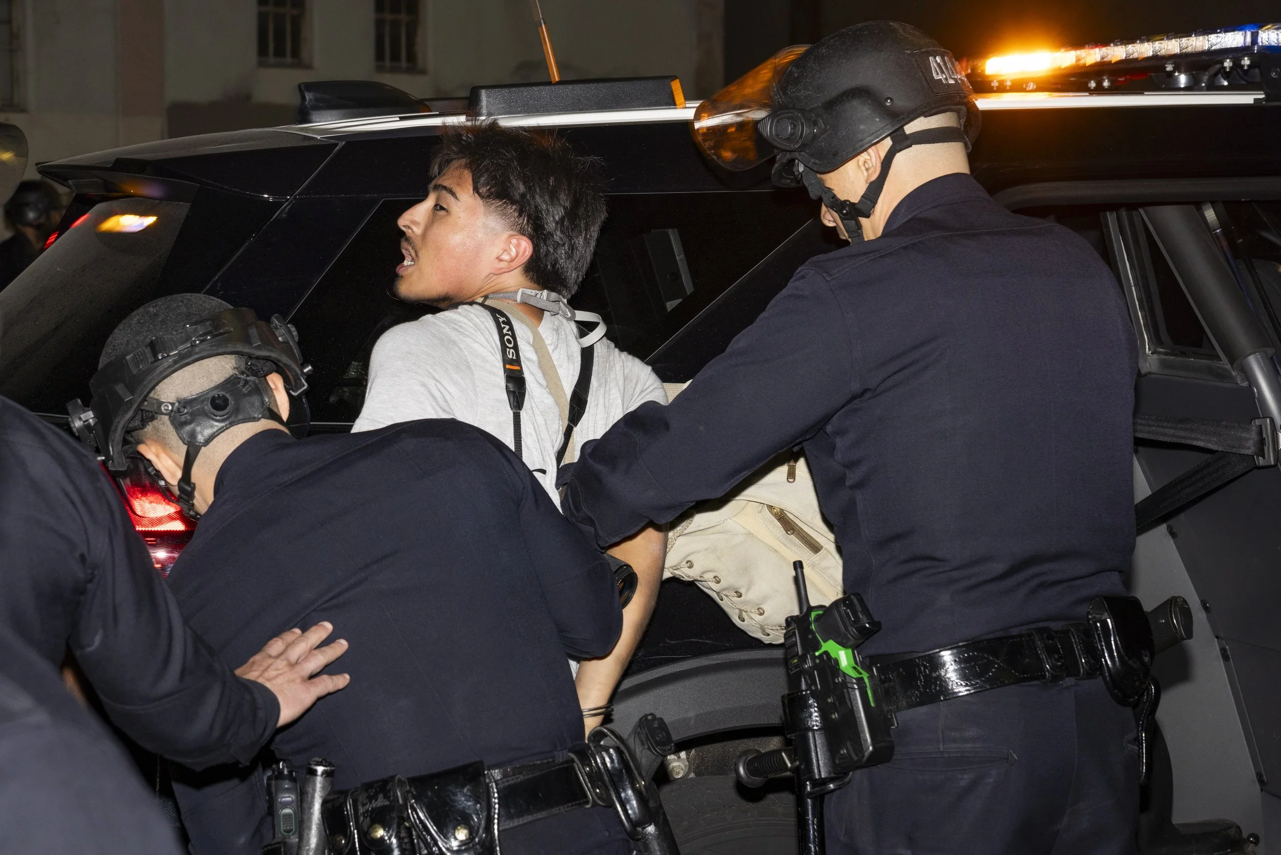  Angel Perez, a freelance photojournalist is arrested by LAPD officers, during an unsanctioned protest at the Metropolitan Detention after the No Kings protest, in downtown Los Angeles, on Saturday, Oct. 17, 2026.  (Jake Crandall | The Corsair) 