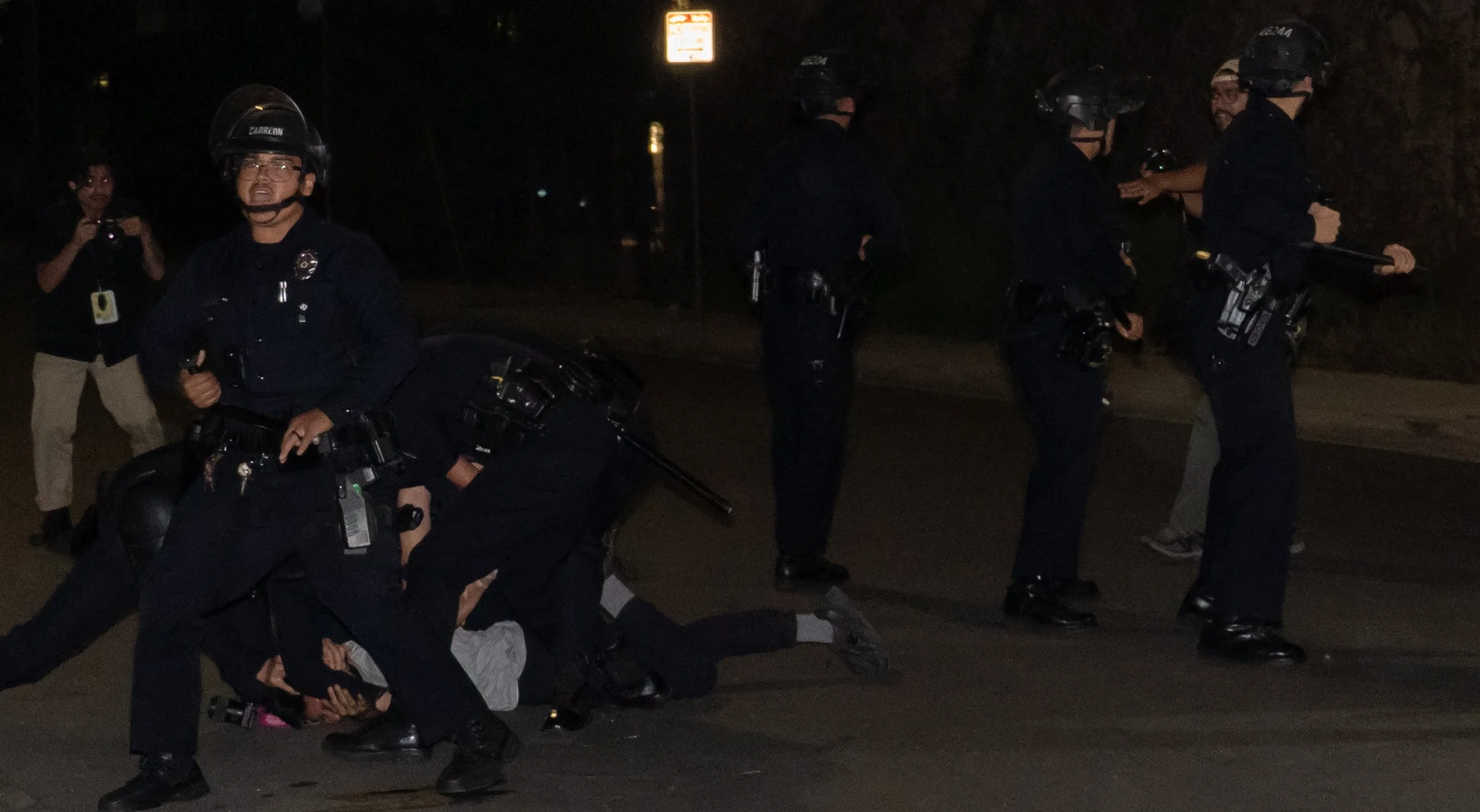  Los Angeles Police Department officers chase and eventually tackle and arrest a student Photojournalist on Ducommun St and Center St in Los Angeles, Calif. On Saturday October 17th, 2026. (Andy Garcia | The Corsair) 