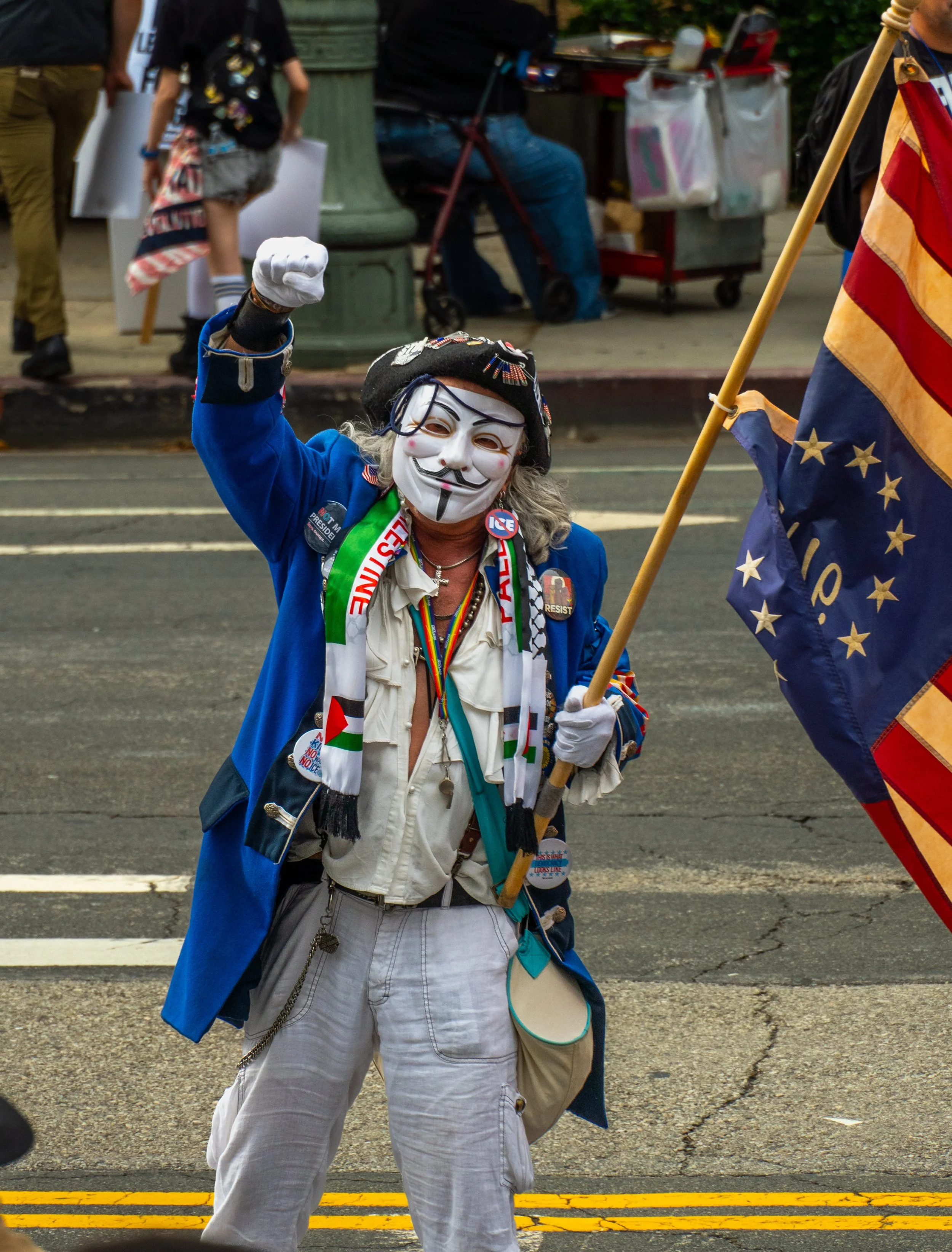  A protestor walks around the front of Los Angeles City Hall waving an upside down U.S. flag while wearing an anonymous mask in Los Angeles, Calif. on Saturday October 17th, 2026. (Andy Garcia | The Corsair) 