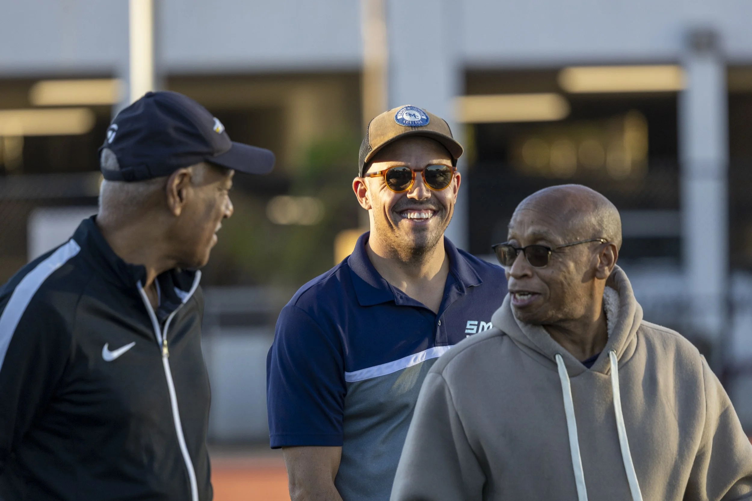  Reggie Ellis (left), recently retired Santa Monica College (SMC) Athletic Director, talks with the new SMC Athletic Director Thomas Briskey (center) during the SMC Homecoming game against the West Los Angeles College Wildcats on Saturday, Oct. 24, 2