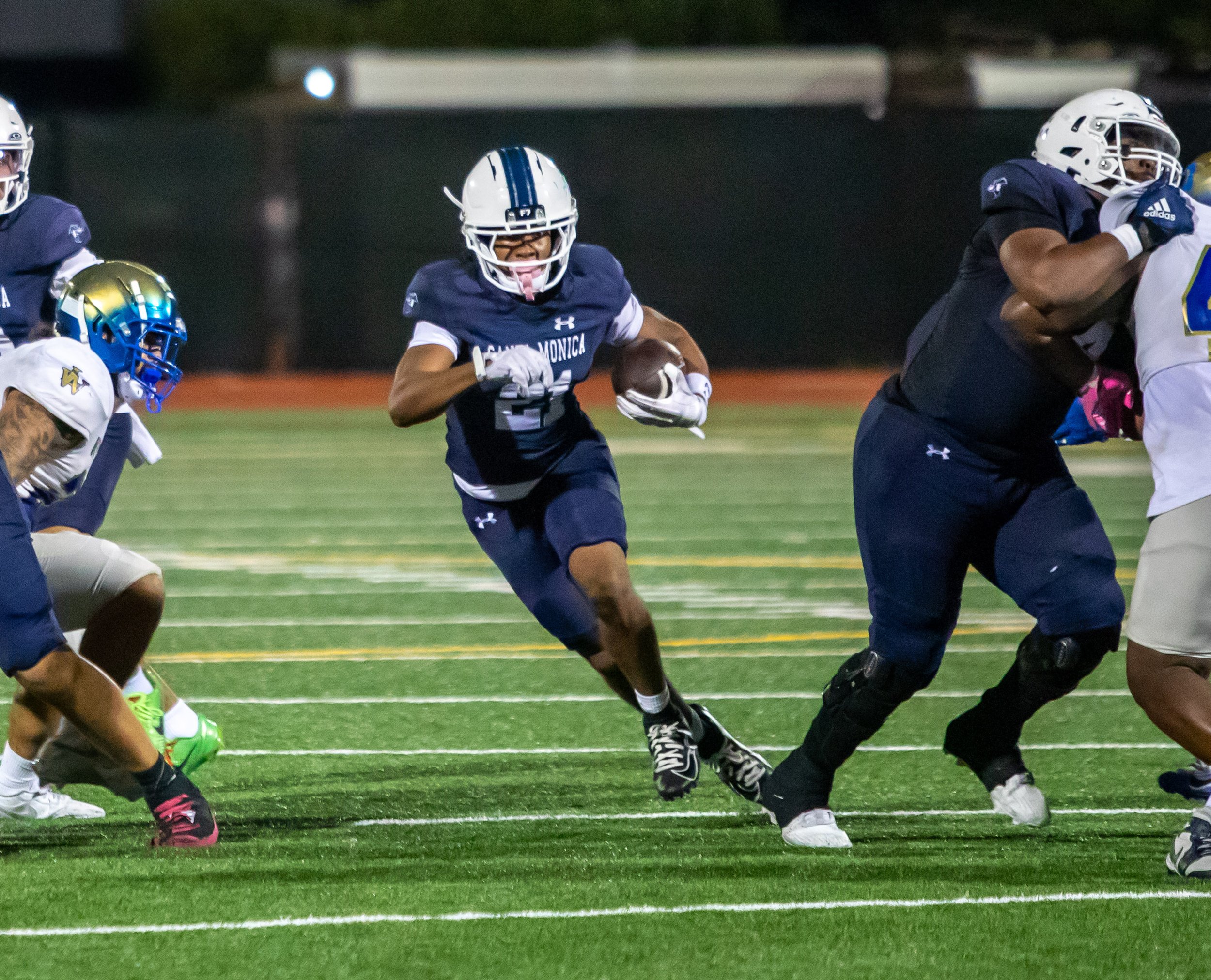  The Santa Monica College Corsairs' running back Landon Davis (21) runs through the gap for a gain at Corsair Field in Santa Monica, Calif., Saturday, October 24, 2026. (The Corsair | Jared Bojorquez) 
