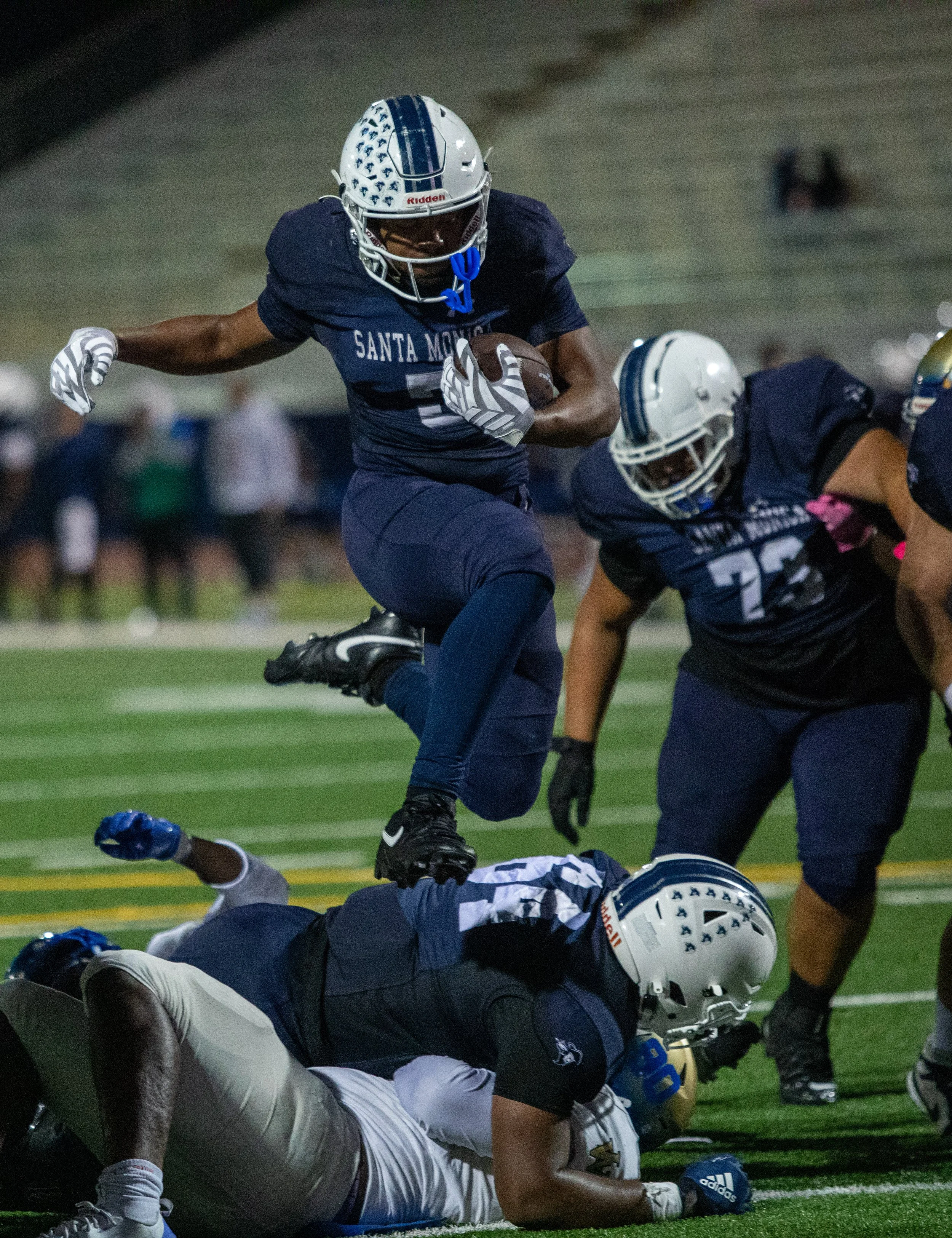  The Santa Monica College Corsairs' running back Dylan Franklin (5) hurdles over defenders into the end zone at Corsair Field in Santa Monica, Calif., Saturday, October 24, 2026. Franklin scored 3 touhcdowns, rushing for over 200 yards leading the Co