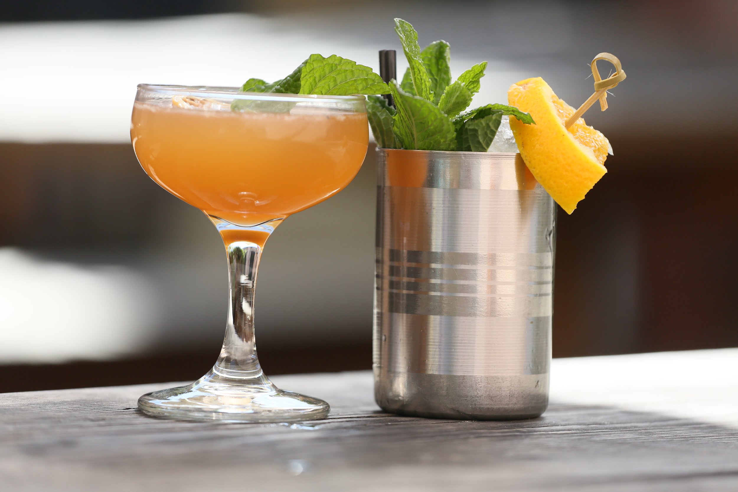 Featured cocktails, 'Paint it Gold' on left, 'Phoenix Like' on right. Both amazing!