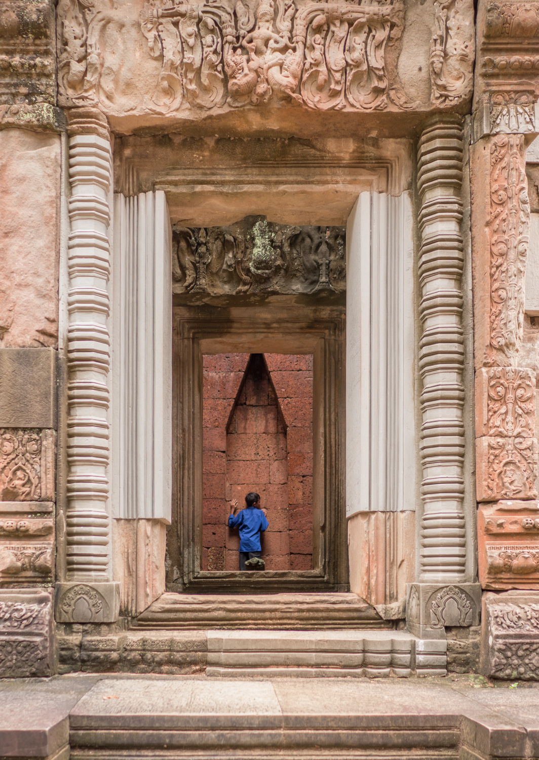 Kid listening to the wall, Cambodia