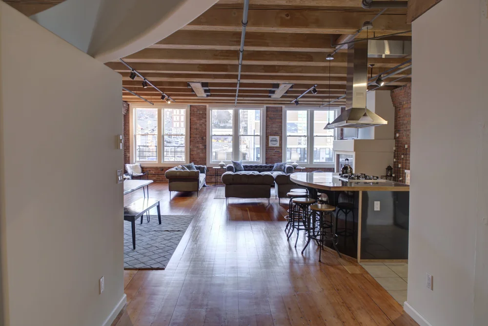 Open loft with kitchen and living area after staging