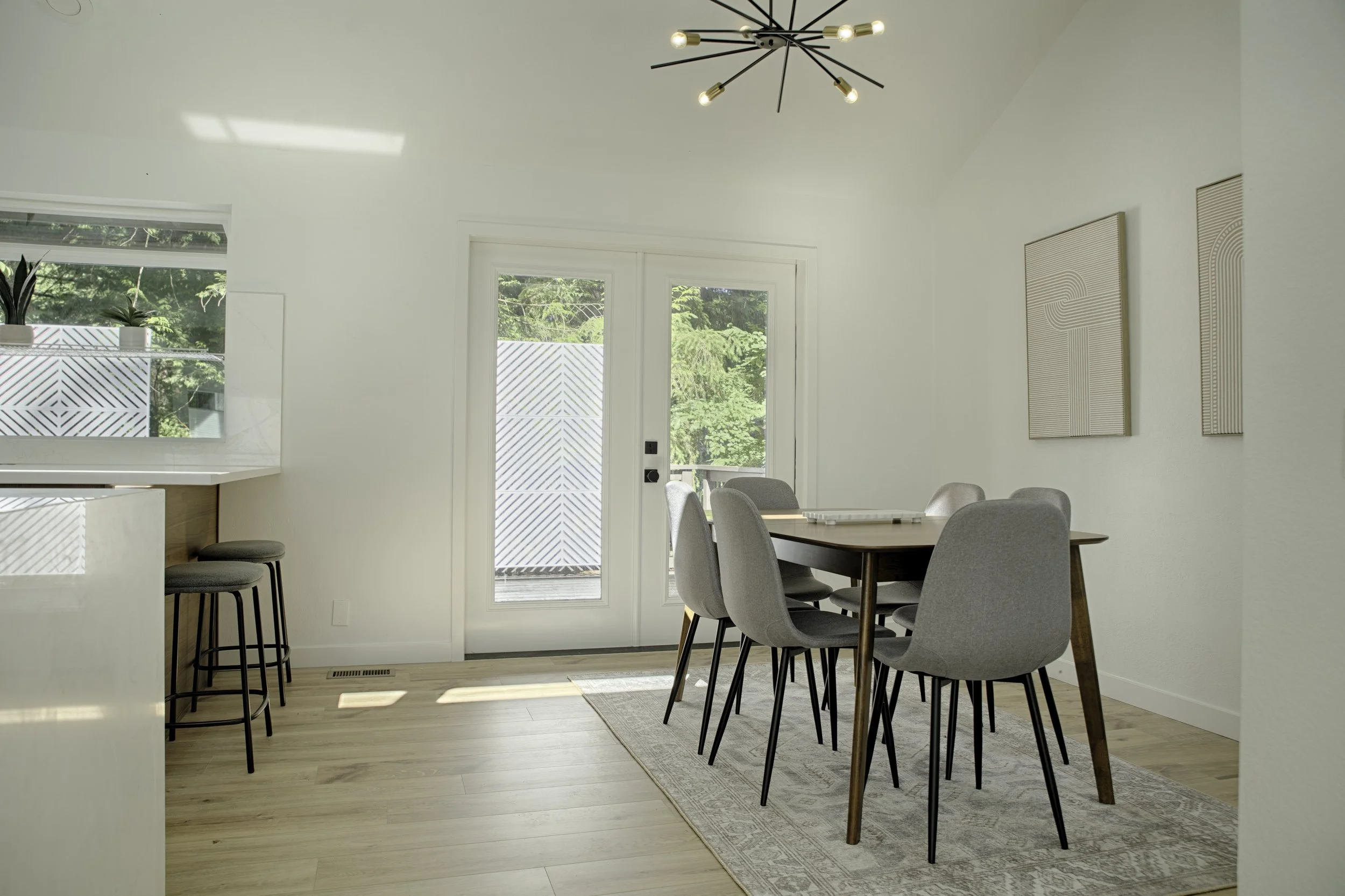French doors open outward from dining onto fire table deck